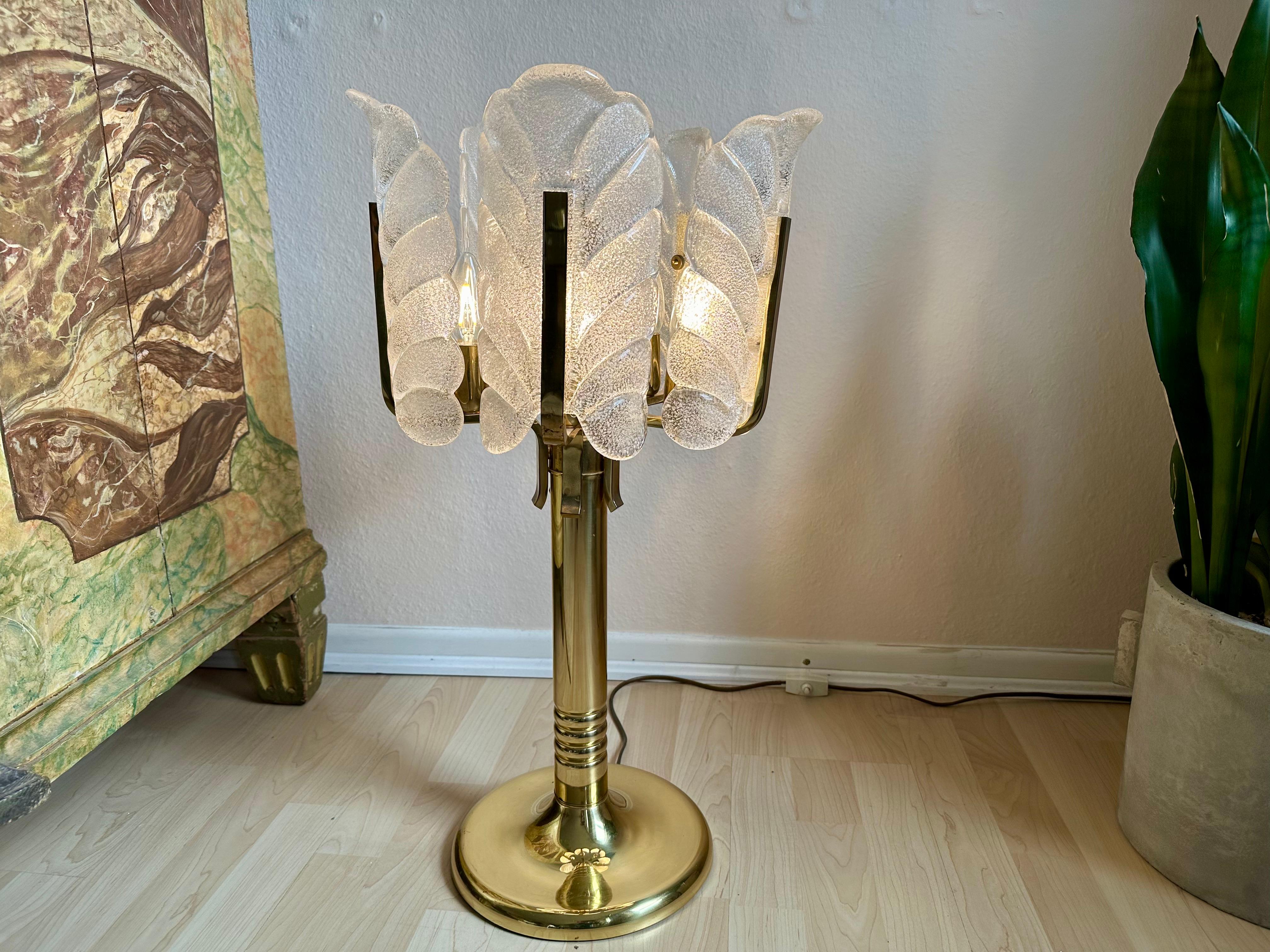 Illuminate your space with a touch of mid-century elegance through this impressive table lamp, meticulously designed by Carl Fagerlund for Orrefors in the 1950s. Crafted from brass, this lamp exudes a classic charm that seamlessly blends into