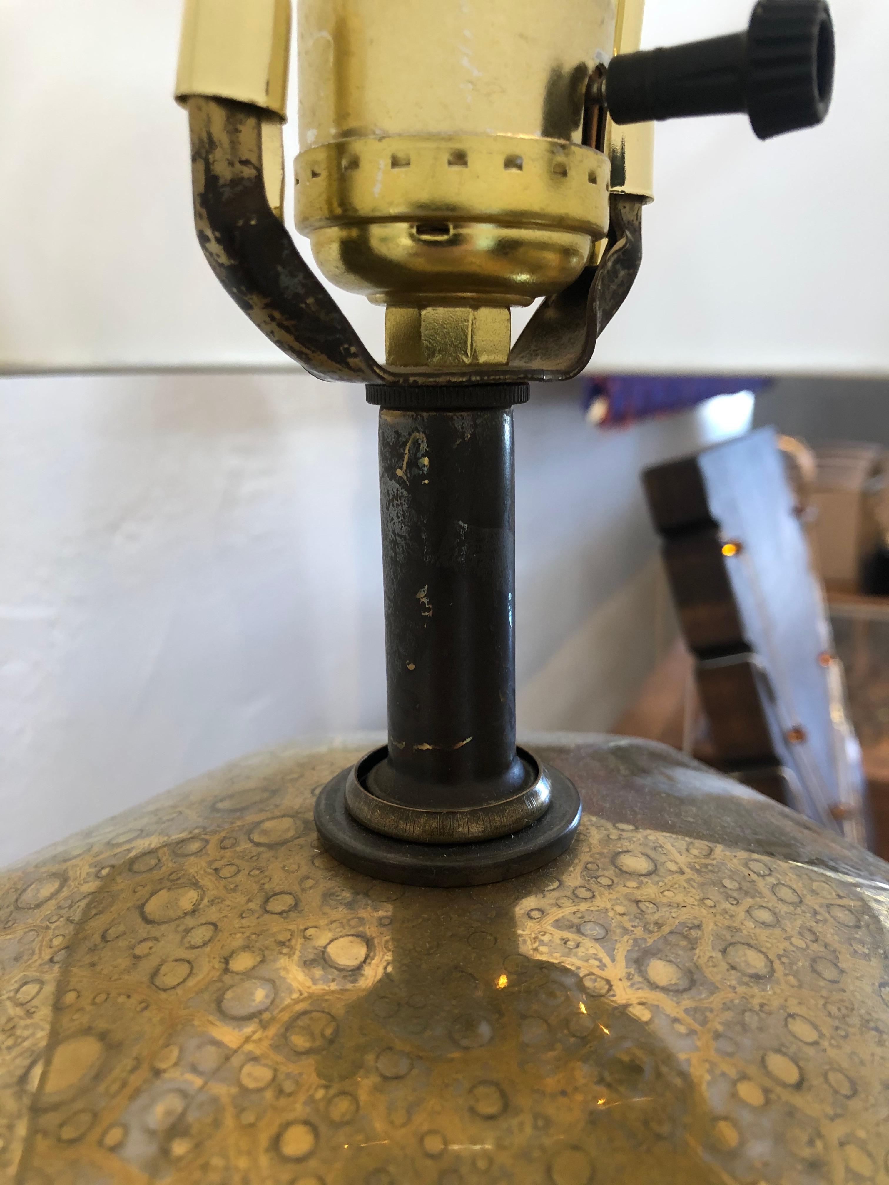 Vintage brass lamp with lamp shade included. Standard U.S. plug. Equipped with brass feet and white paint detailed design.