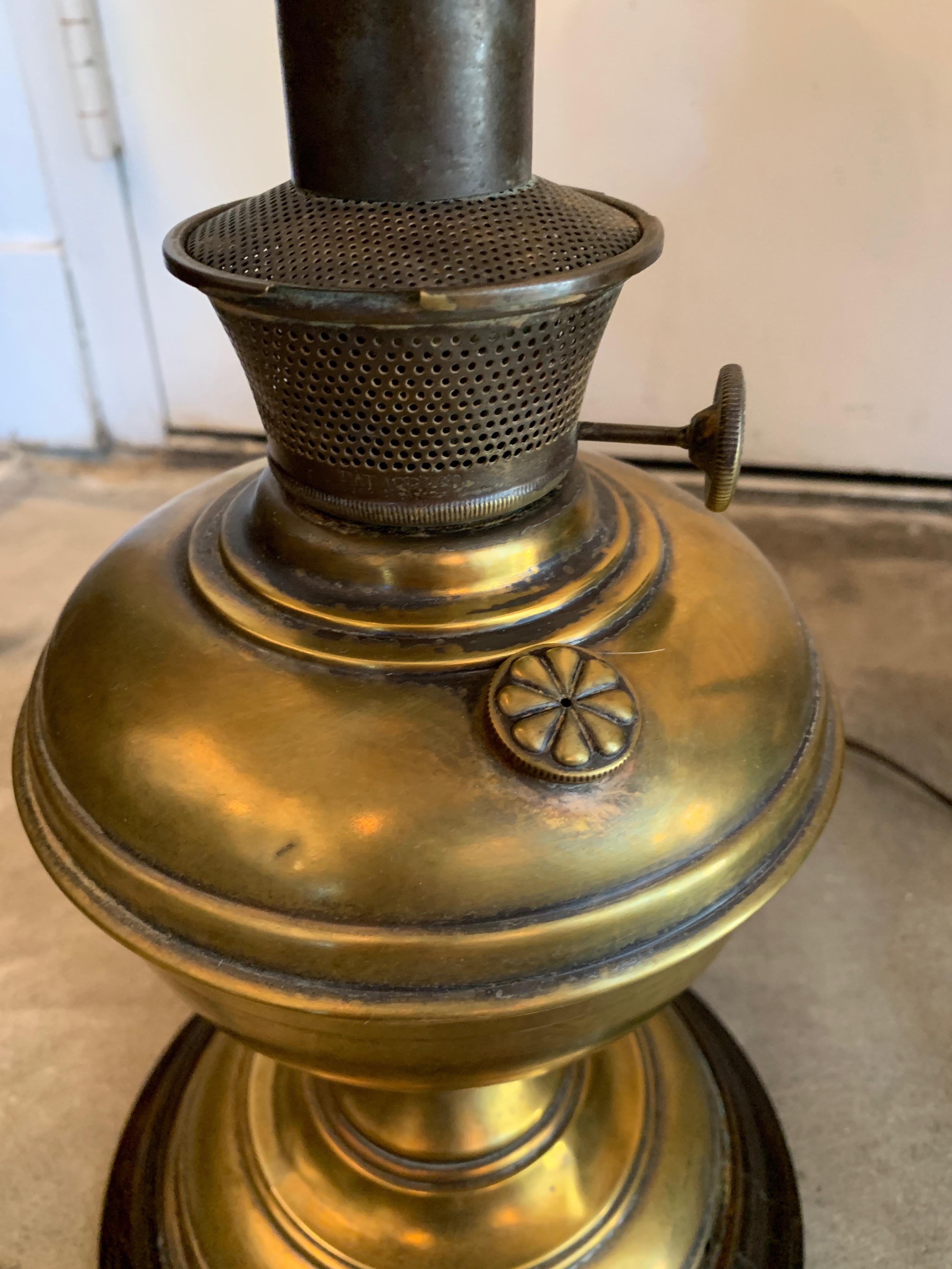 Tall brass lamps with wood base and decorative knobs. All original pieces with new shades. Knob is stamped with Beacon Home Supply Co, Kansas City MD. Look to be renovated gas lamps, a gorgeous find. Measurements given with shade. Sold as a pair.