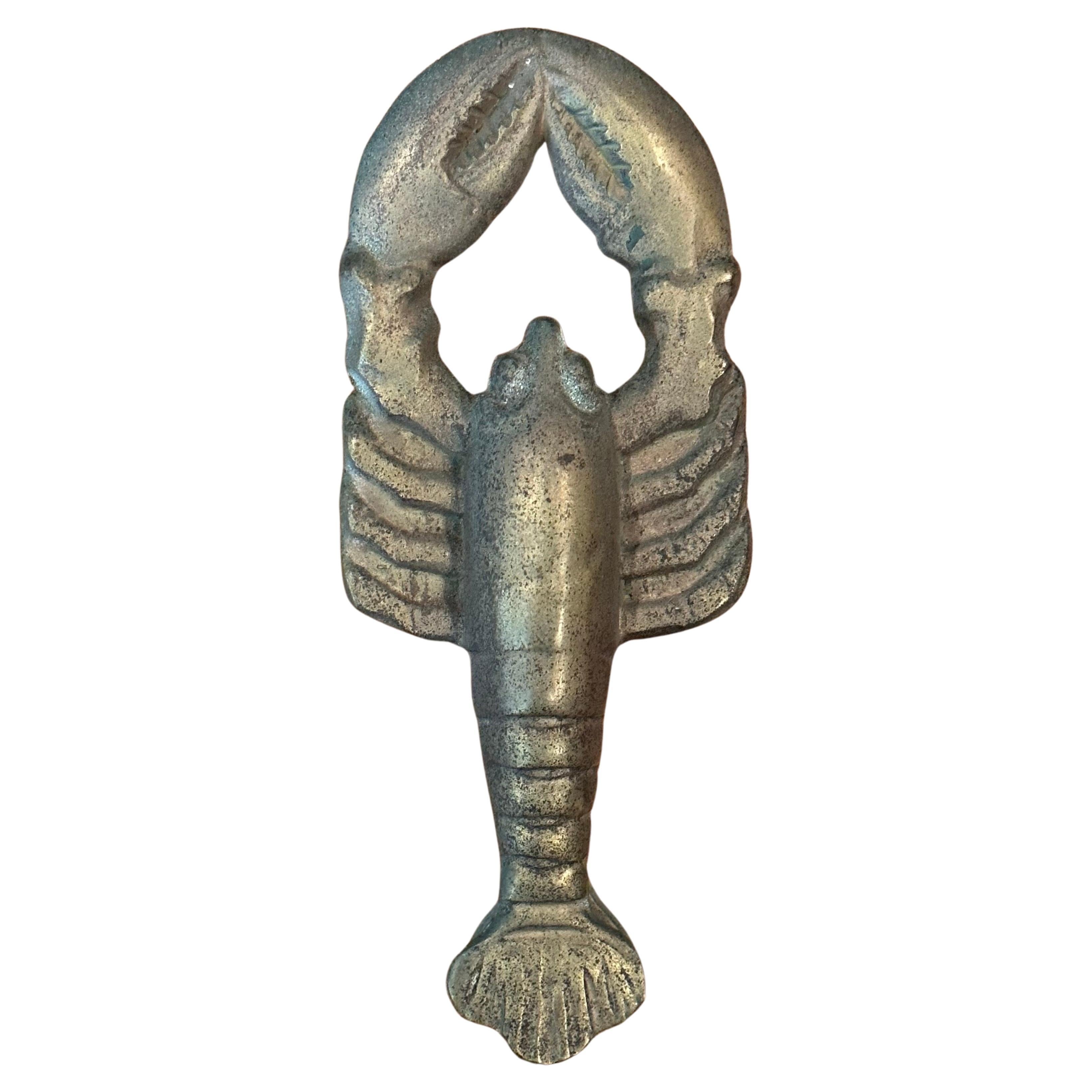Well worn vintage brass lobster door knocker, circa 1960s. The piece is made of cast brass and is quite solid. The knocker is in very good vintage condition and measures 4