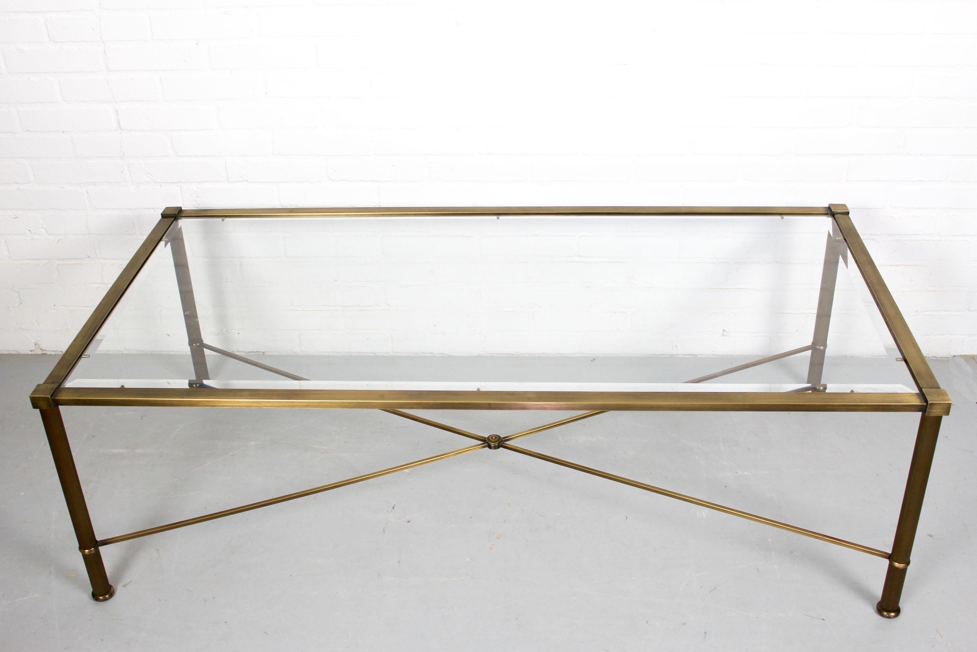 A very stylish and beautiful vintage side tables with glass top, this table date from the 1960s. The condition is great for its age, the metal is painted in brass-look and the glass shelve with facet edges has no chips or cracks.
