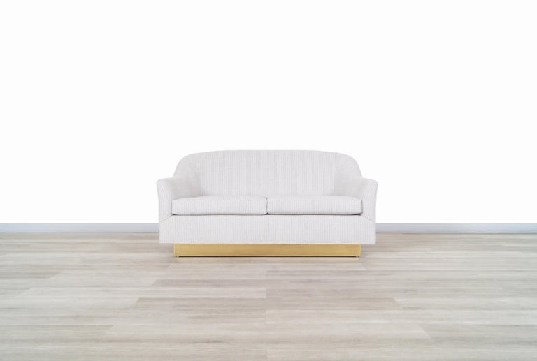 Beautiful vintage brass loveseat designed by Milo Baughman for Thayer Coggin in the United States, circa 1970s. This loveseat has an elegant design that highlights the rounded edges on both the backrest and the armrests. This piece has been