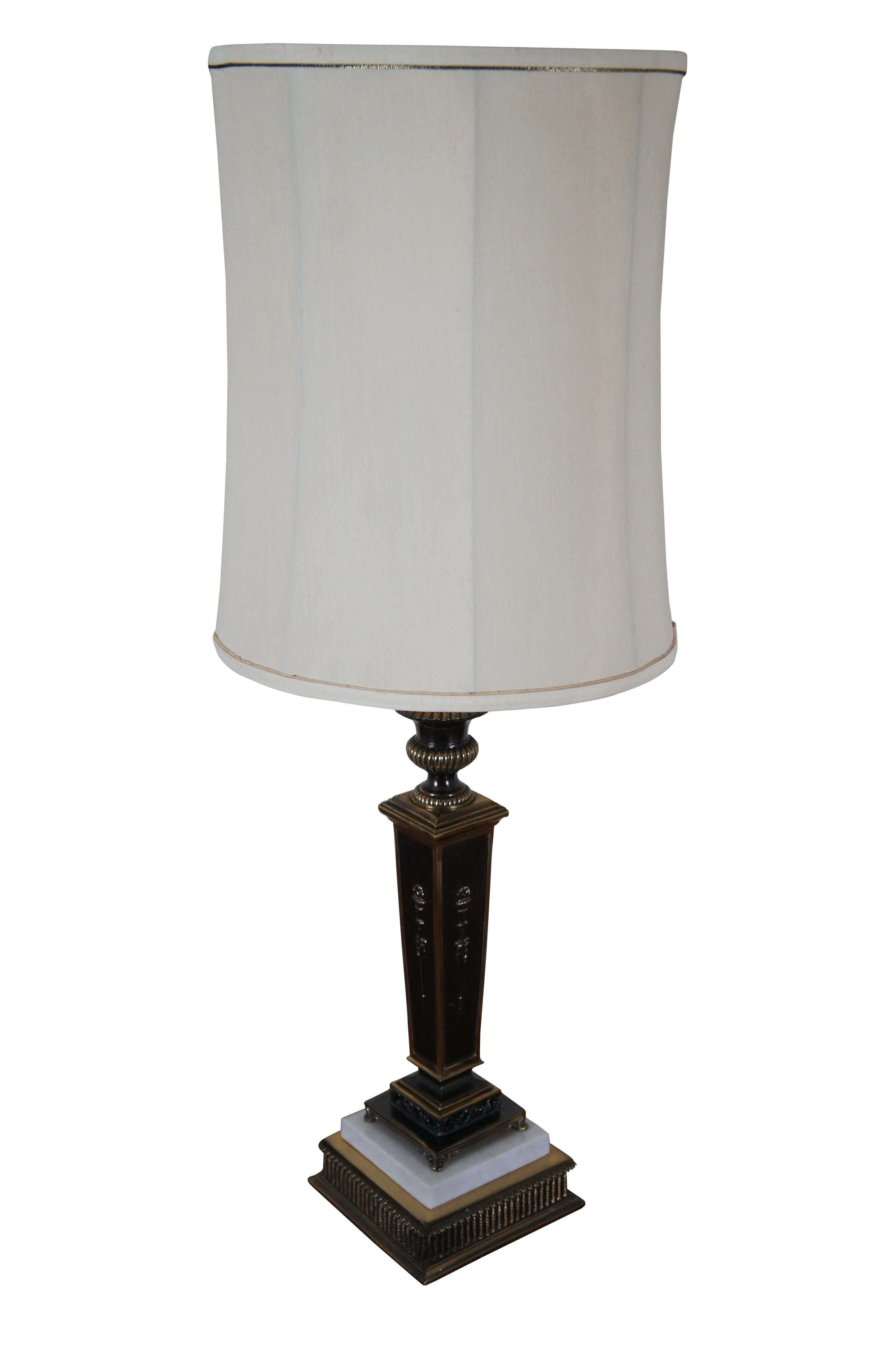 Vintage Empire style torchiere / square column / candlestick shaped table lamp, crafted of brass with dark accents and white marble on the base. Includes cap shaped finial and cylindrical white cloth shade with narrow trim.

Dimensions:
6.75