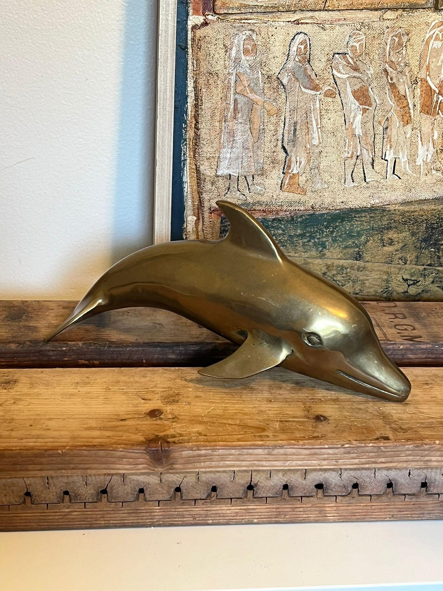 Vintage brass MCM dolphin figurines. Possibly from the 70s. Nice Patina and character. Vintage Condition as pictured. Listing is for described item only. 

Dimensions. 11”W ; 4”D ; 5”H