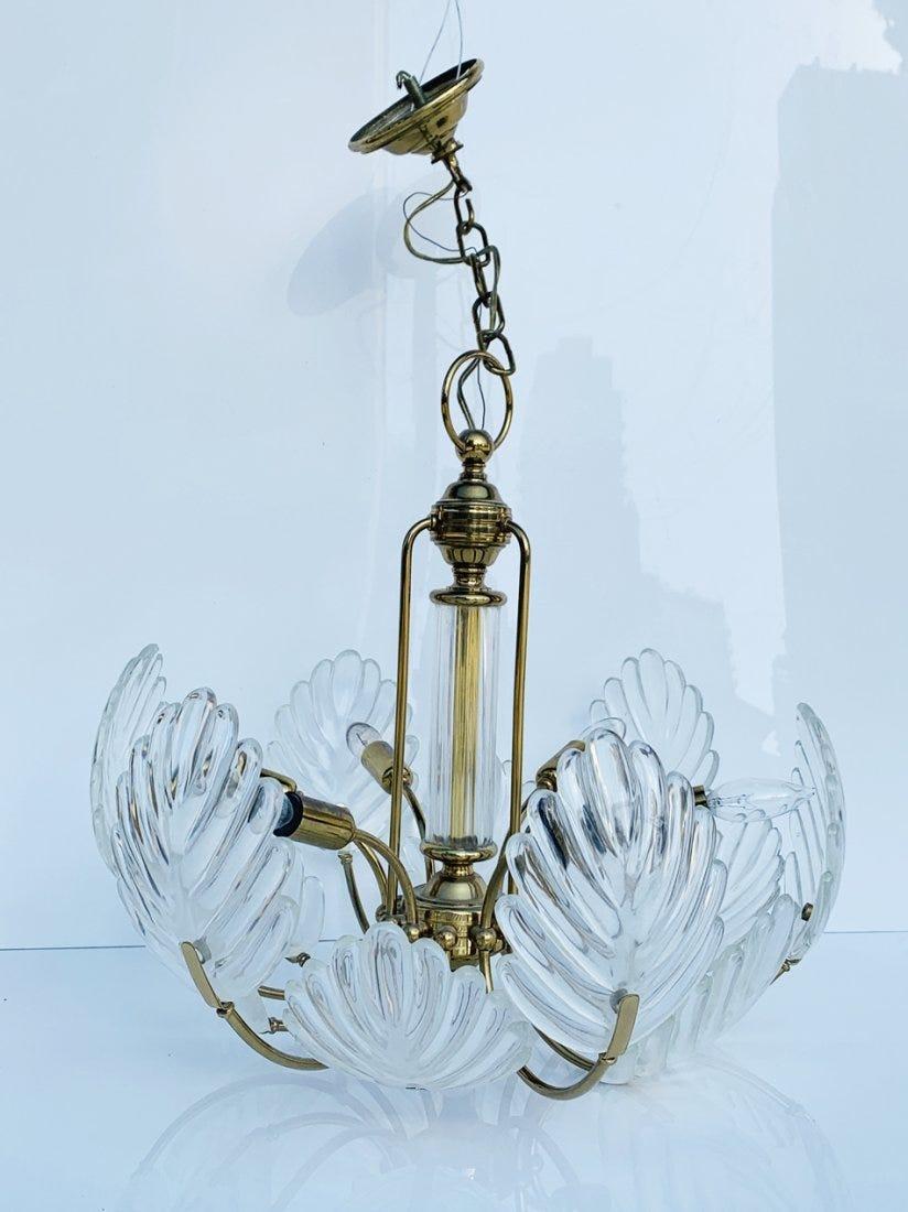 Stunningly beautiful Murano glass and brass chandelier.
The chandelier has 12 Murano glass leaves mounted on a brass frame and with 6 light bulbs. 
The chandelier shows beautifully and is in very good condition with some tarnishing to metal but no