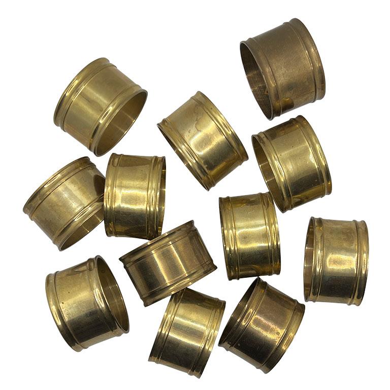 Elevate your dining table with this set of 12 vintage solid brass napkin rings. They are the perfect combination of timeless design and sophisticated charm. Crafted from durable solid brass, each napkin ring features a classic cylindrical shape with
