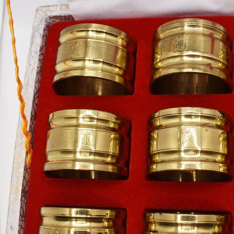 A set of 12 vintage brass napkin rings engraved with the letter 