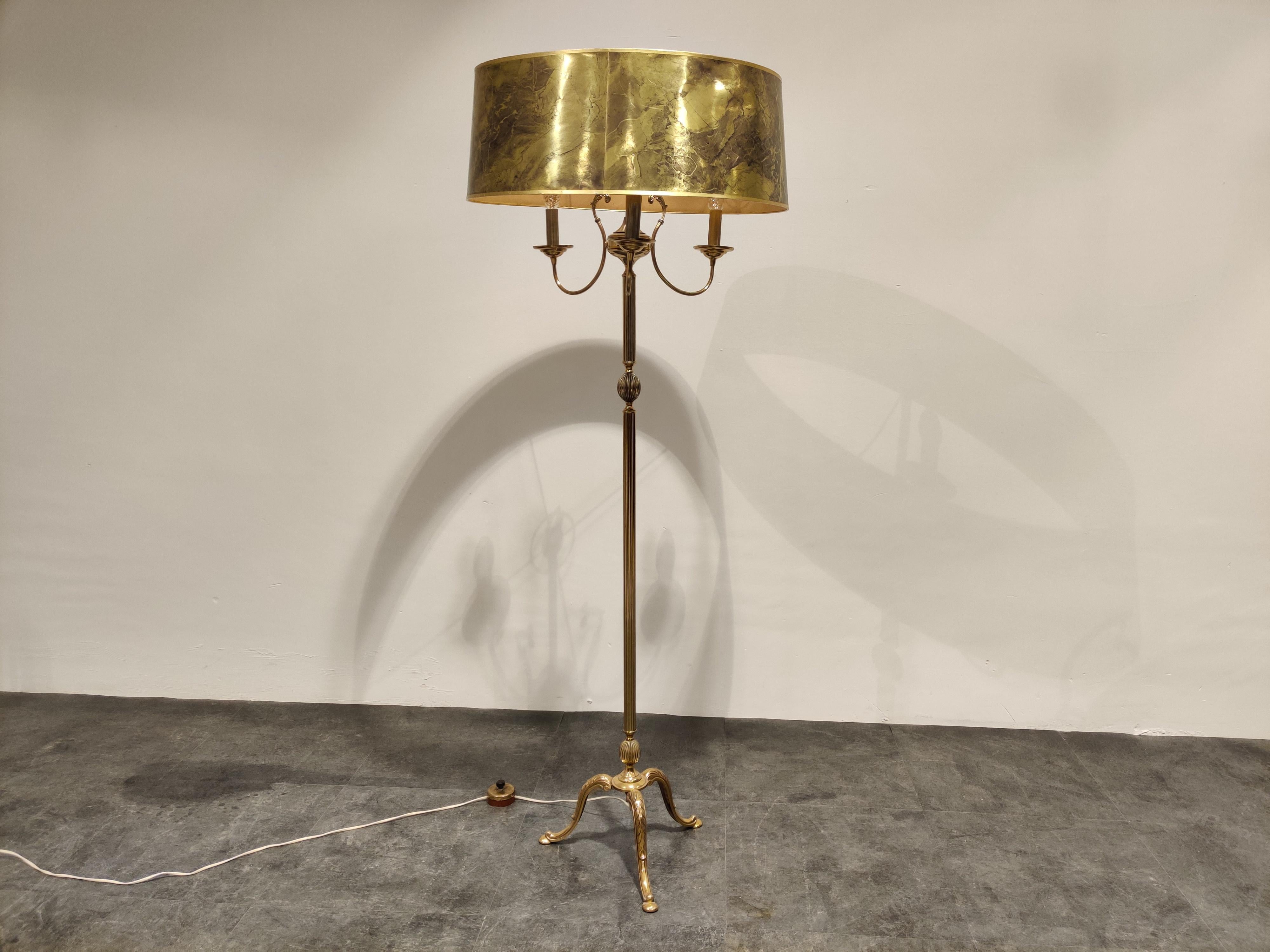 Vintage brass neoclassical tripod floor lamp with three candelabra lightpoints.

The lamp comes with it's beautiful original flamed golden shade.

The floor lamp emits a beautiful light and has a great look.

Works with 3 E14 light
