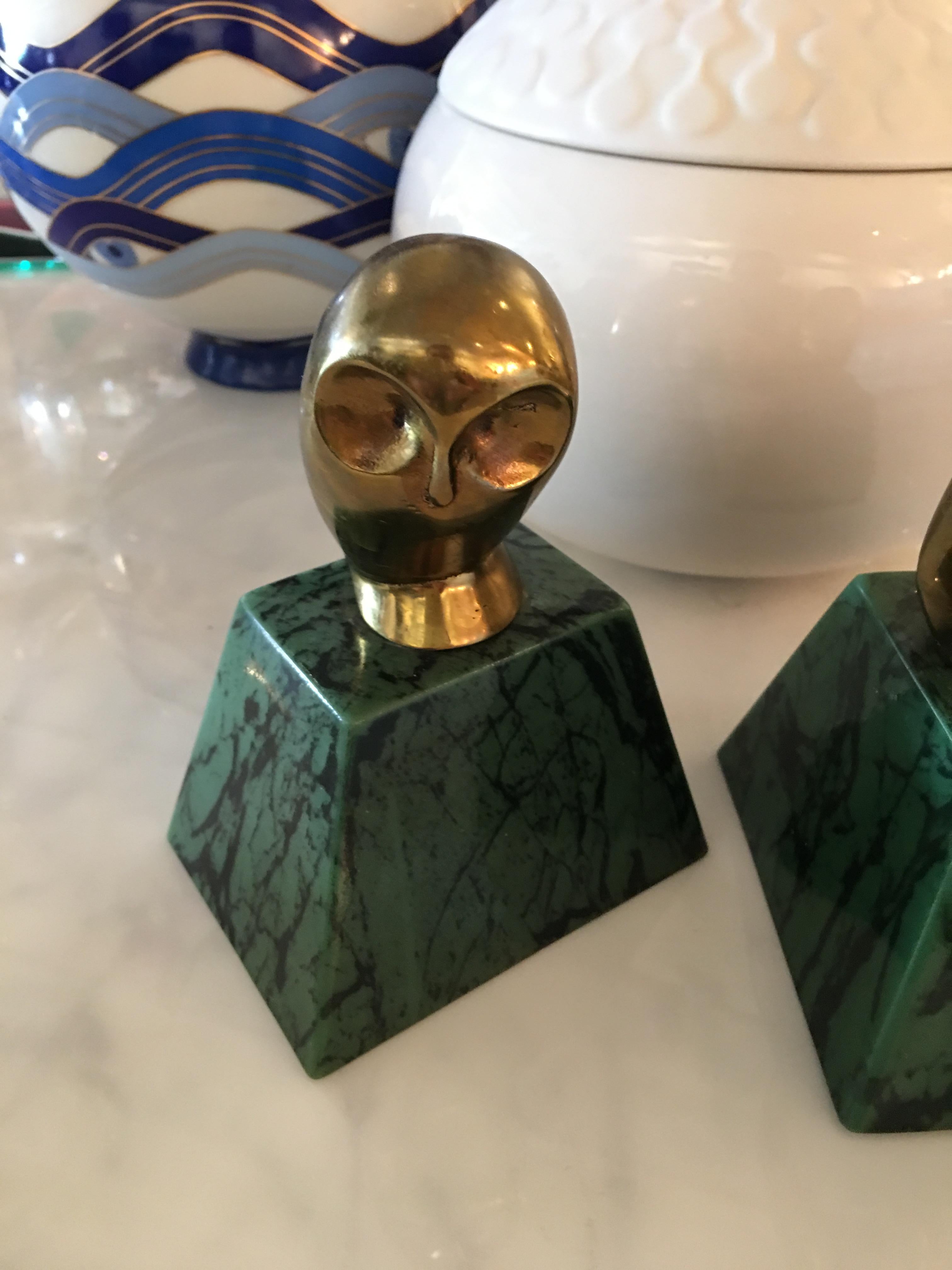 Book ends are cast in brass and sit atop green marble. Quite charming and lively!