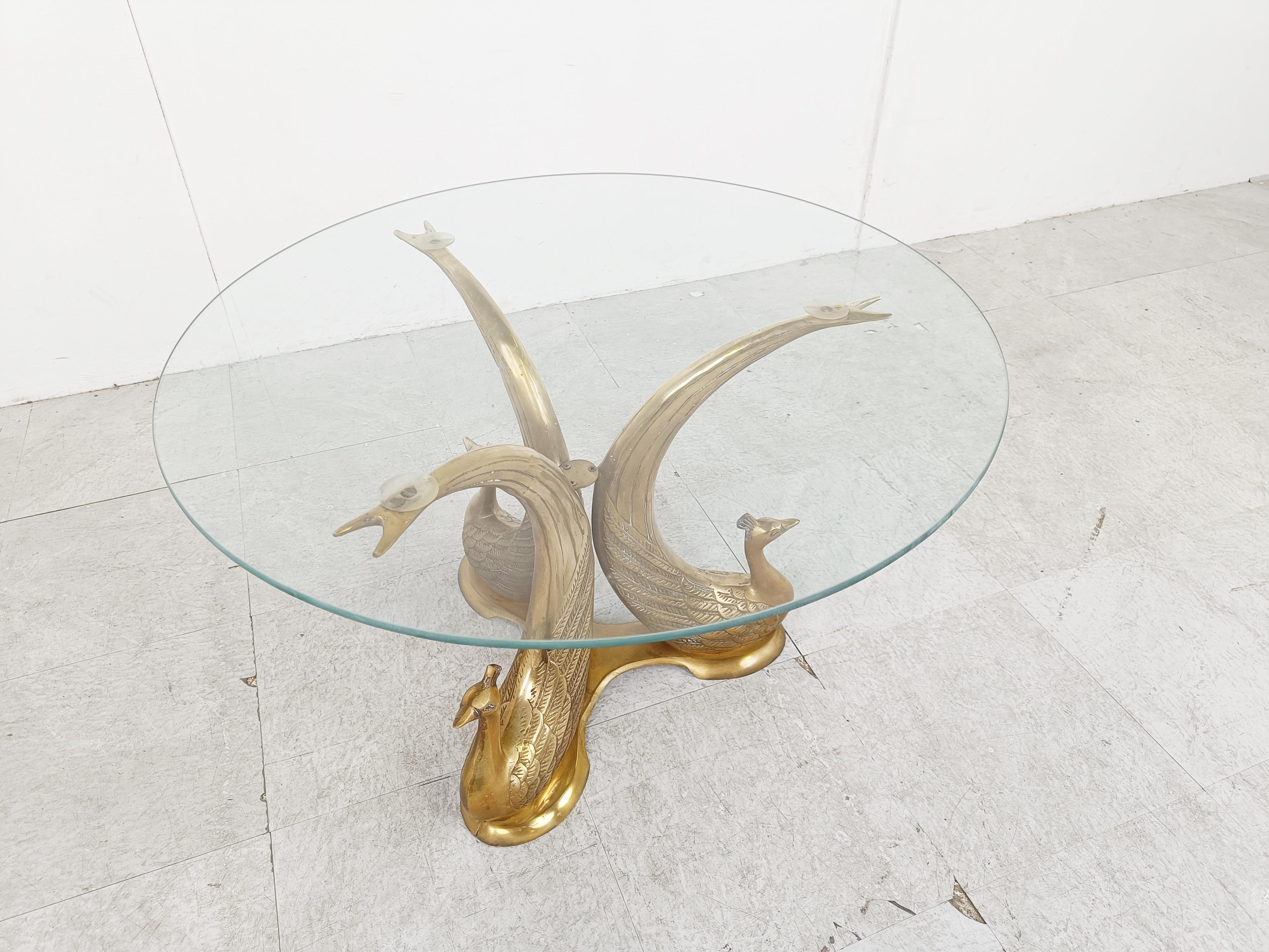 Hollywood regency brass elephant coffee table.

The coffee table consists of a brass base featuring 3 brass peacocks and a clear glass top.

We have 3 of these tables available

Dimensions:
Height: 42cm/16.53