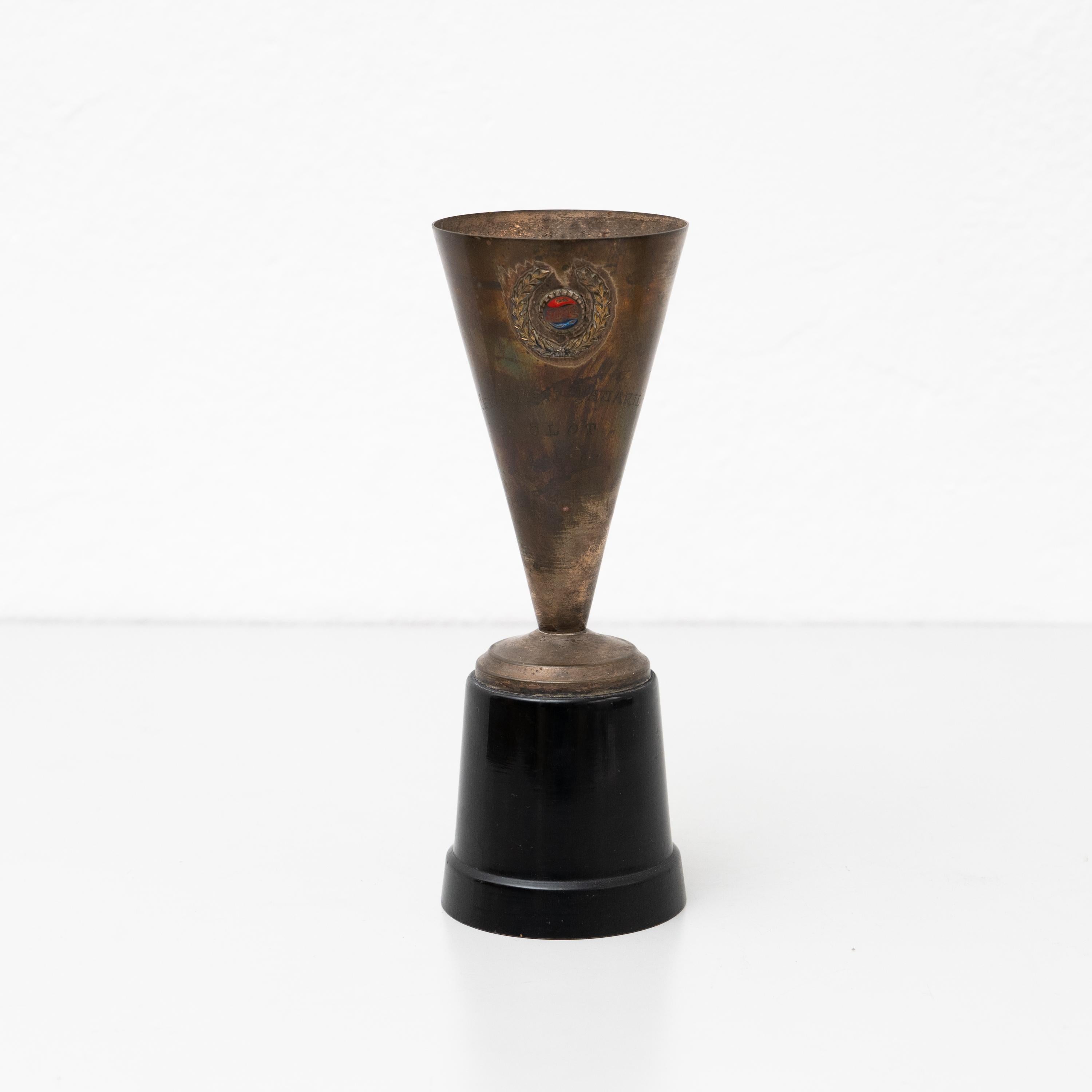 Vintage Brass Pepsi Trophy.

Made by unknown manufacturer in Spain, circa 1960.

In original condition, with minor wear consistent with age and use, preserving a beautiful patina.

Materials:
Brass.