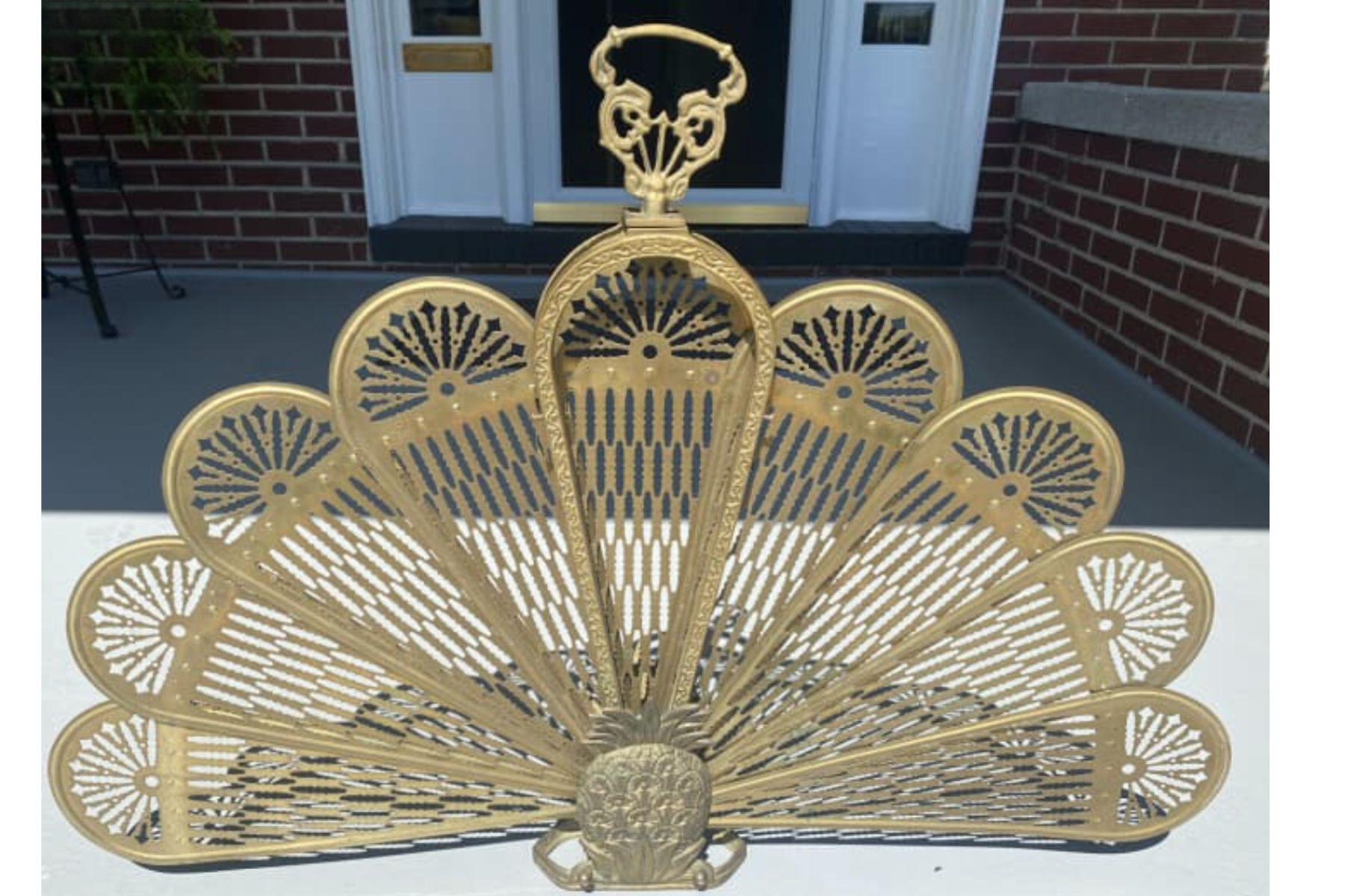 Make a statement with this vintage brass pineapple fireplace screen, a stunning mid-century fan-style fire screen perfect for adding warmth and elegance to your home. Featuring a beautifully detailed pineapple motif, this piece symbolizes