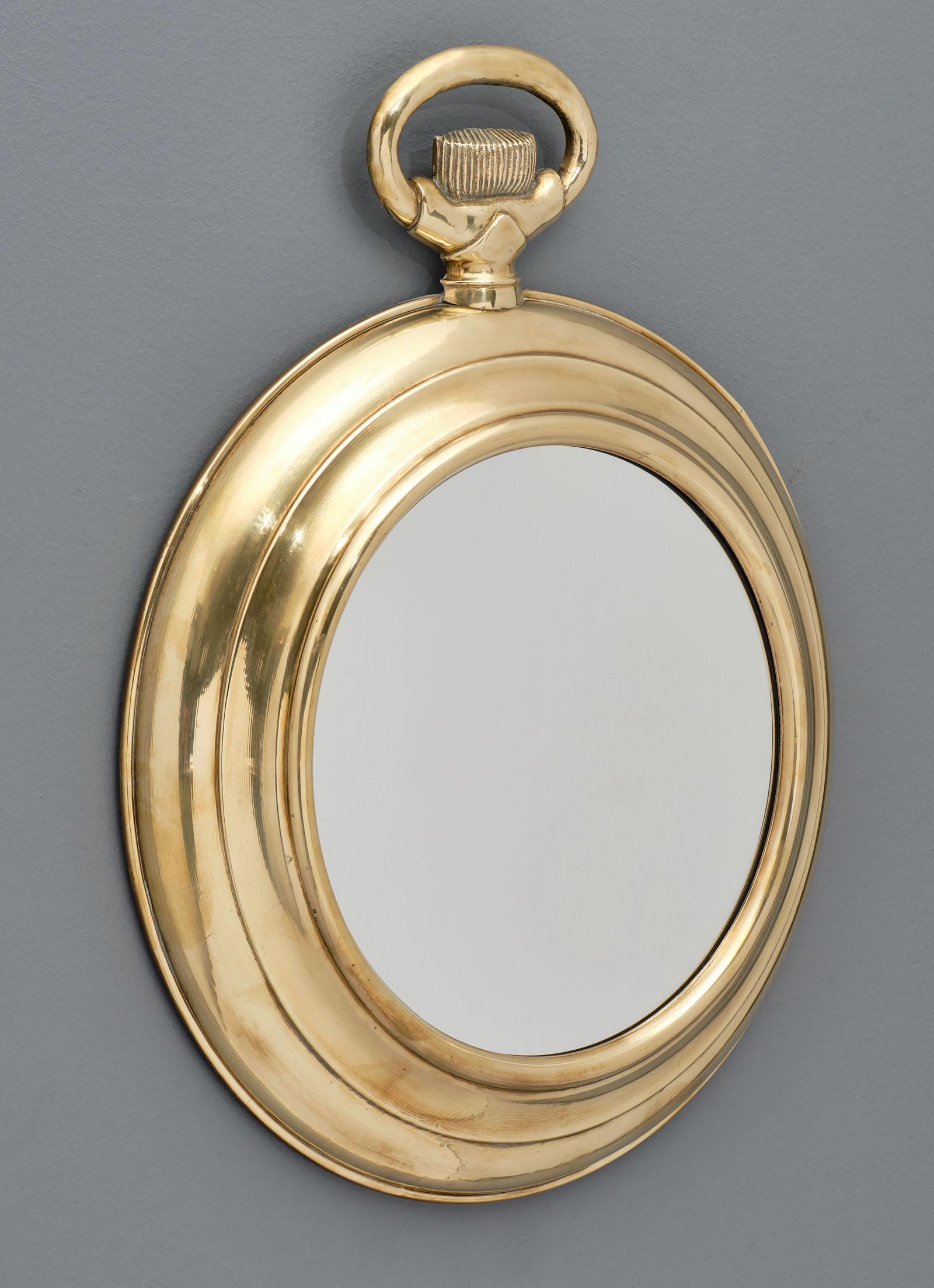 Brass vintage pocket watch mirror from the Art Deco period in France. We love the unique and unexpected shape of this vintage piece!