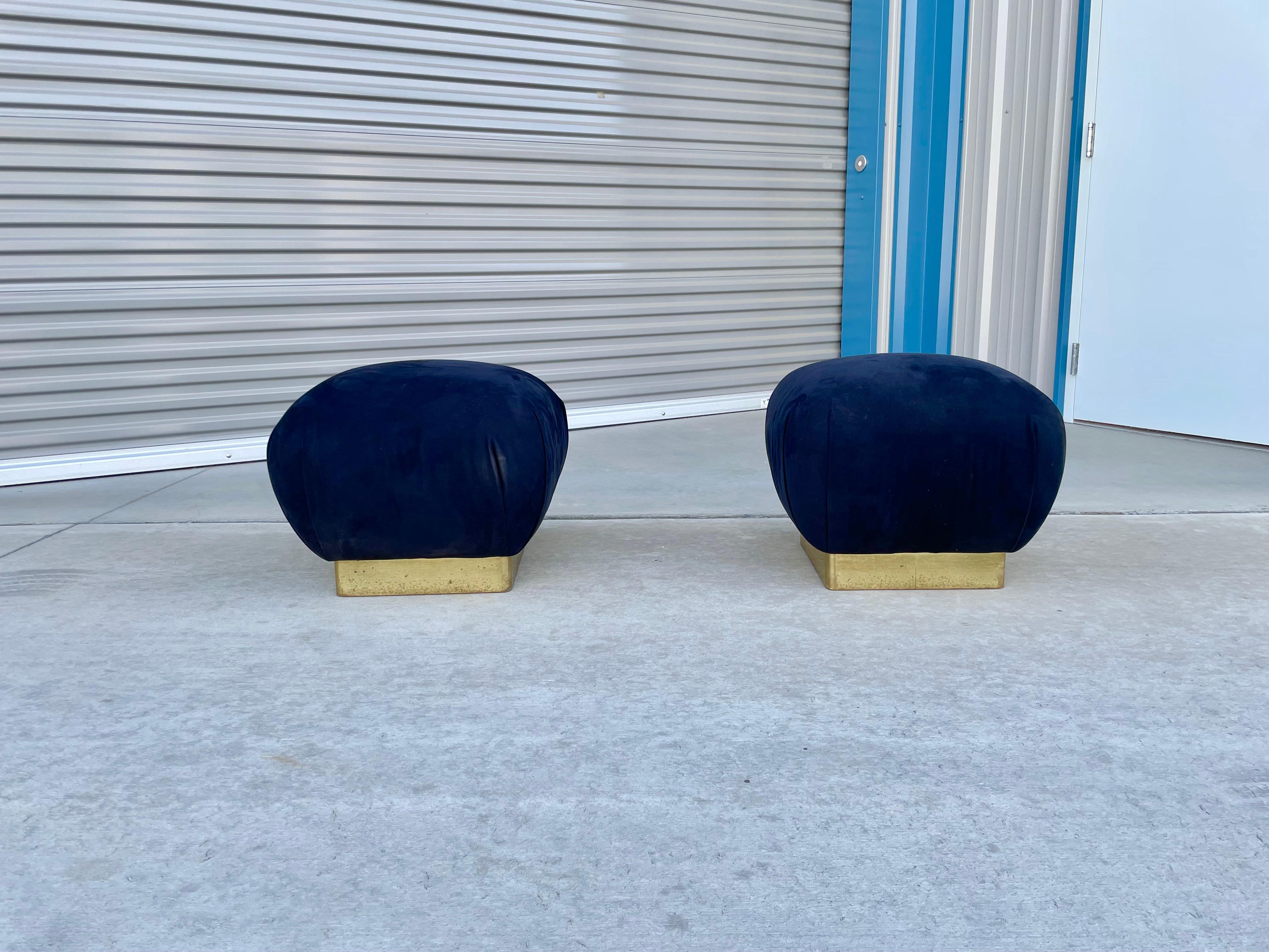Wonderful pair of vintage brass poufs/ottomans designed by Marge Carson in the United States, circa 1970s. Each pouf features a brass base, and each cushion seems to have the design of a delicious souffle that is about to burst.