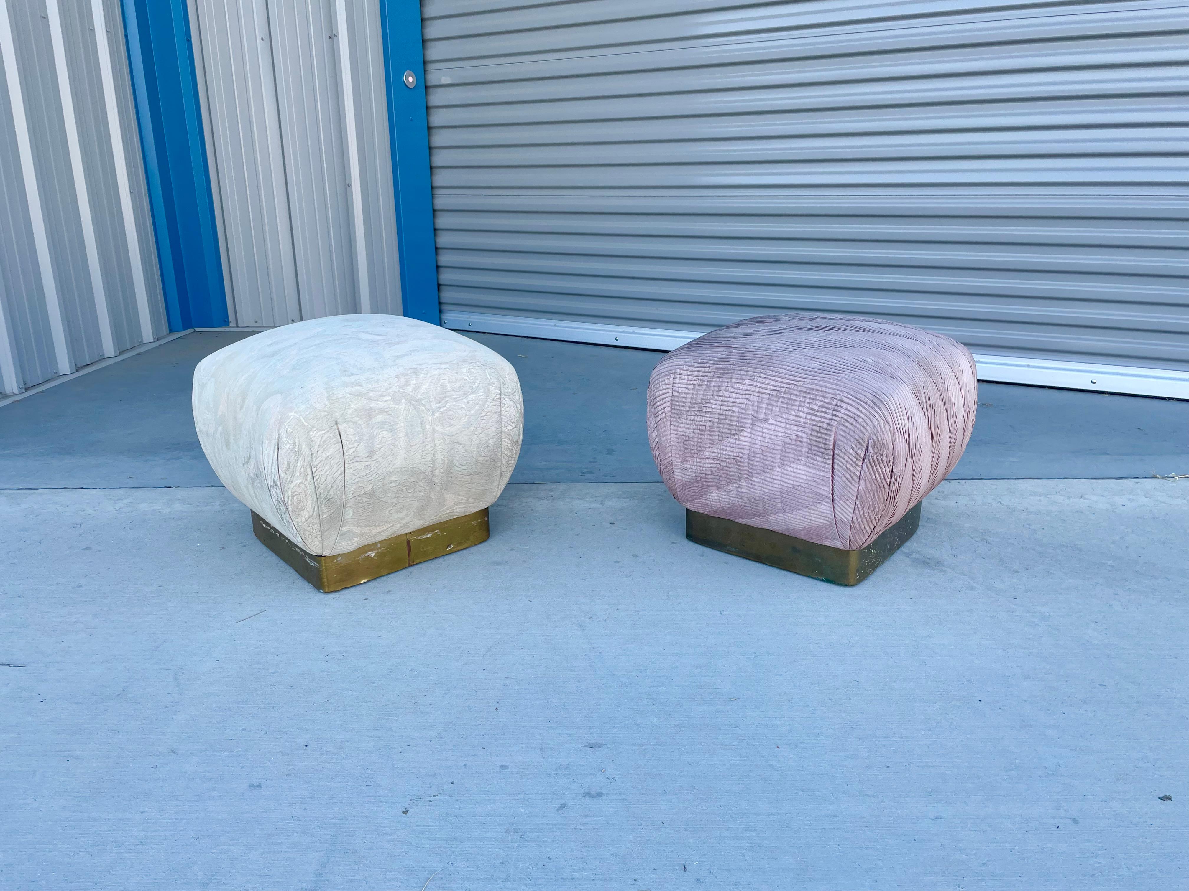 Wonderful pair of vintage brass poufs/ottomans designed by Marge Carson in the United States, circa 1970s. Each pouf features a brass base, and each cushion seems to have the design of a delicious souffle that is about to burst. This is ideal for