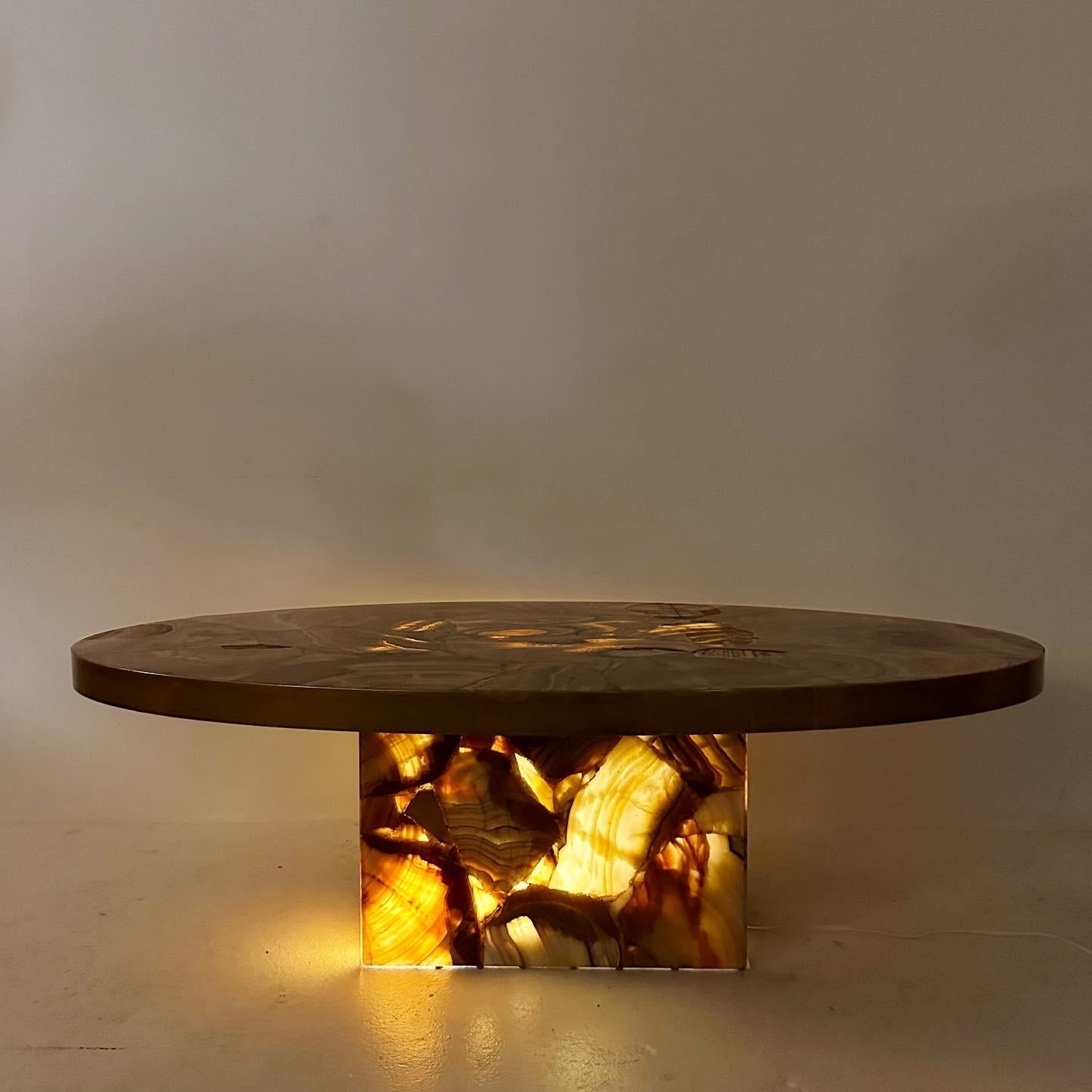 Brass rimmed oval alabaster coffee table (often marked as onyx). Made in Acapulco in the 1970s. The stone is translucent, so the table can be illuminated.
