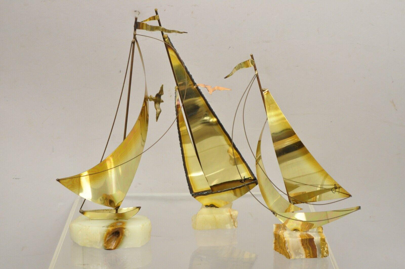 Vintage brass sailboat Mid-Century Modern sculpture Jere DeMott - 3 Pc Set. Item features (3) sculptures, brass construction, onyx stone base, signatures to each sculpture, one sculpture by Curtis Jere, (1) by DeMott, (1) believed to be DeMott as