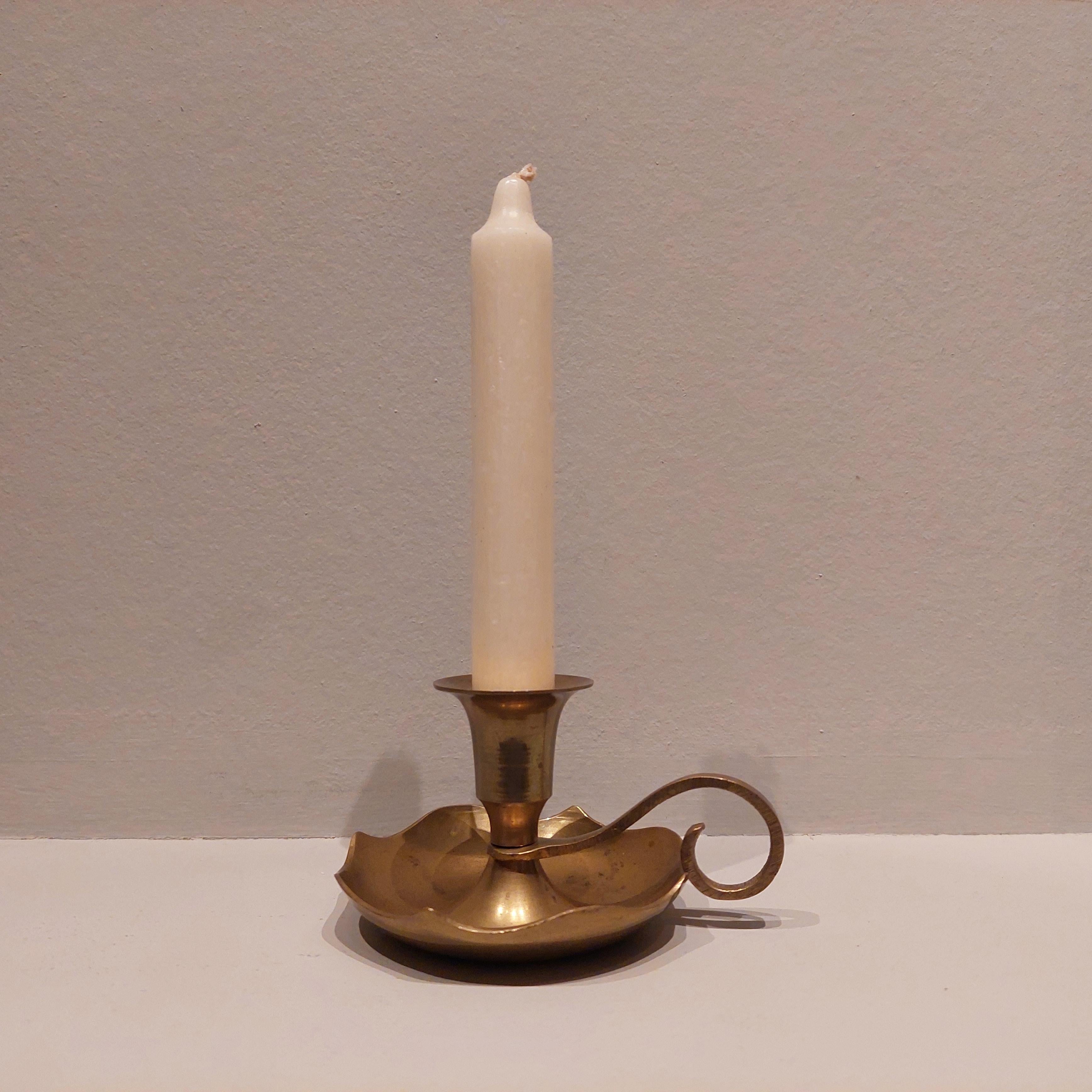 A gorgeous small vintage brass candle holder with scalloped edge and little side handle in lovely vintage condition. 
A very sweet piece and great fun to style.  
A vintage  brass Wee willy wink style candle stick holder.
Candle holder with
