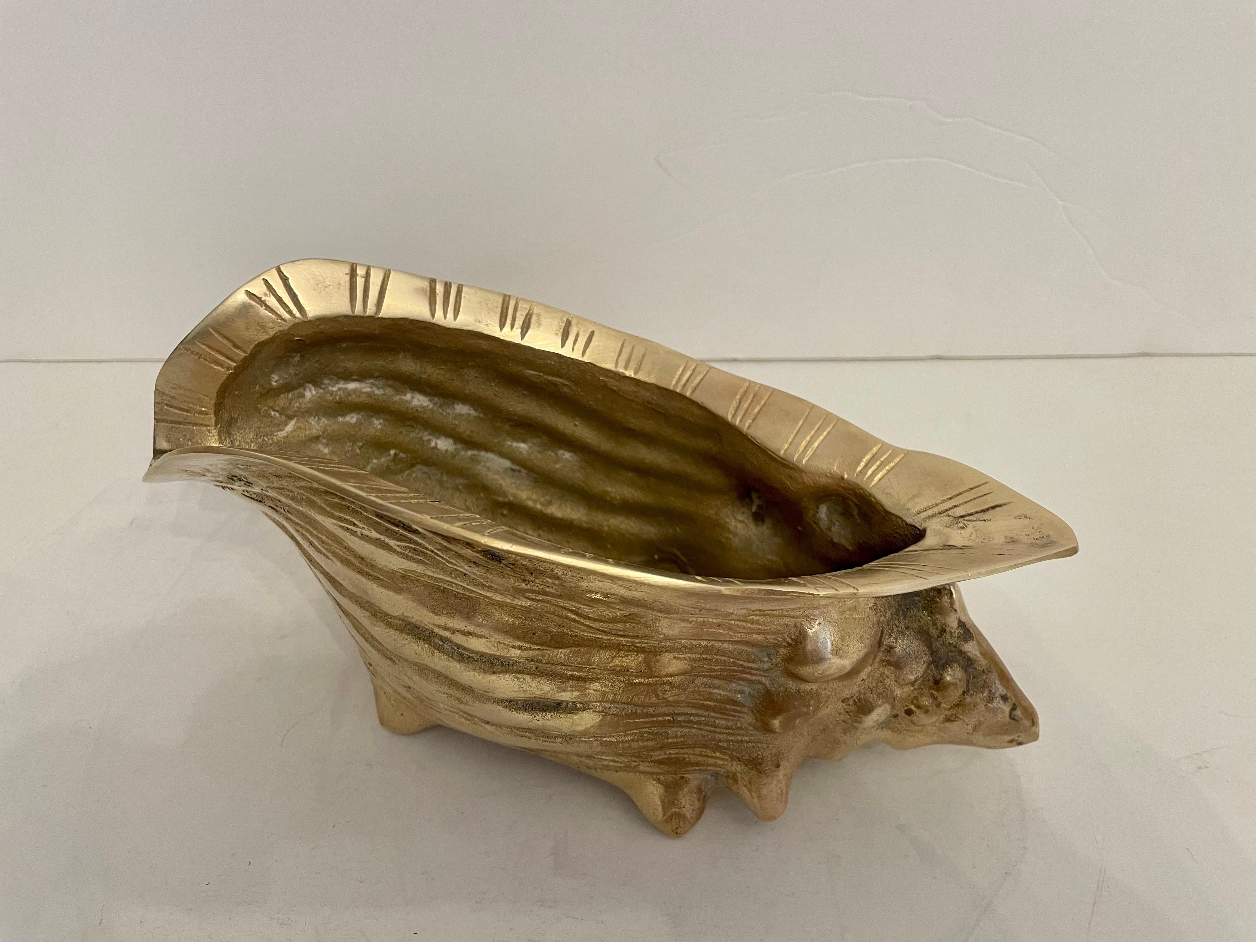 Hollywood Regency vintage brass seashell nautilus planter. Very detailed. Good overall condition with minor wear to from age and use. Can be used inside or out. Great for air plants. 9” wide x 4.5 wide x 4” tall. Hand polished.