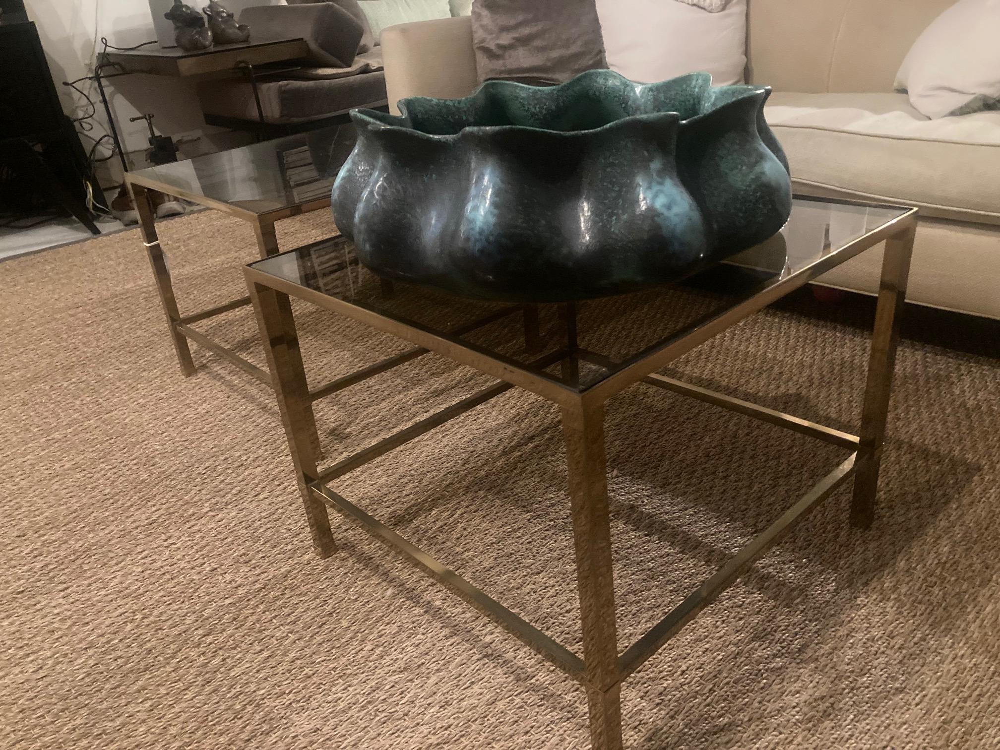 Vintage Modern brass & bronze glass side tables. 

Petite, modern glass side table with bronze glass. These side tables would be a wonderful addition for a seating area. 
Wear commensurate with age and use. Glass has a chipped edge (additional cost
