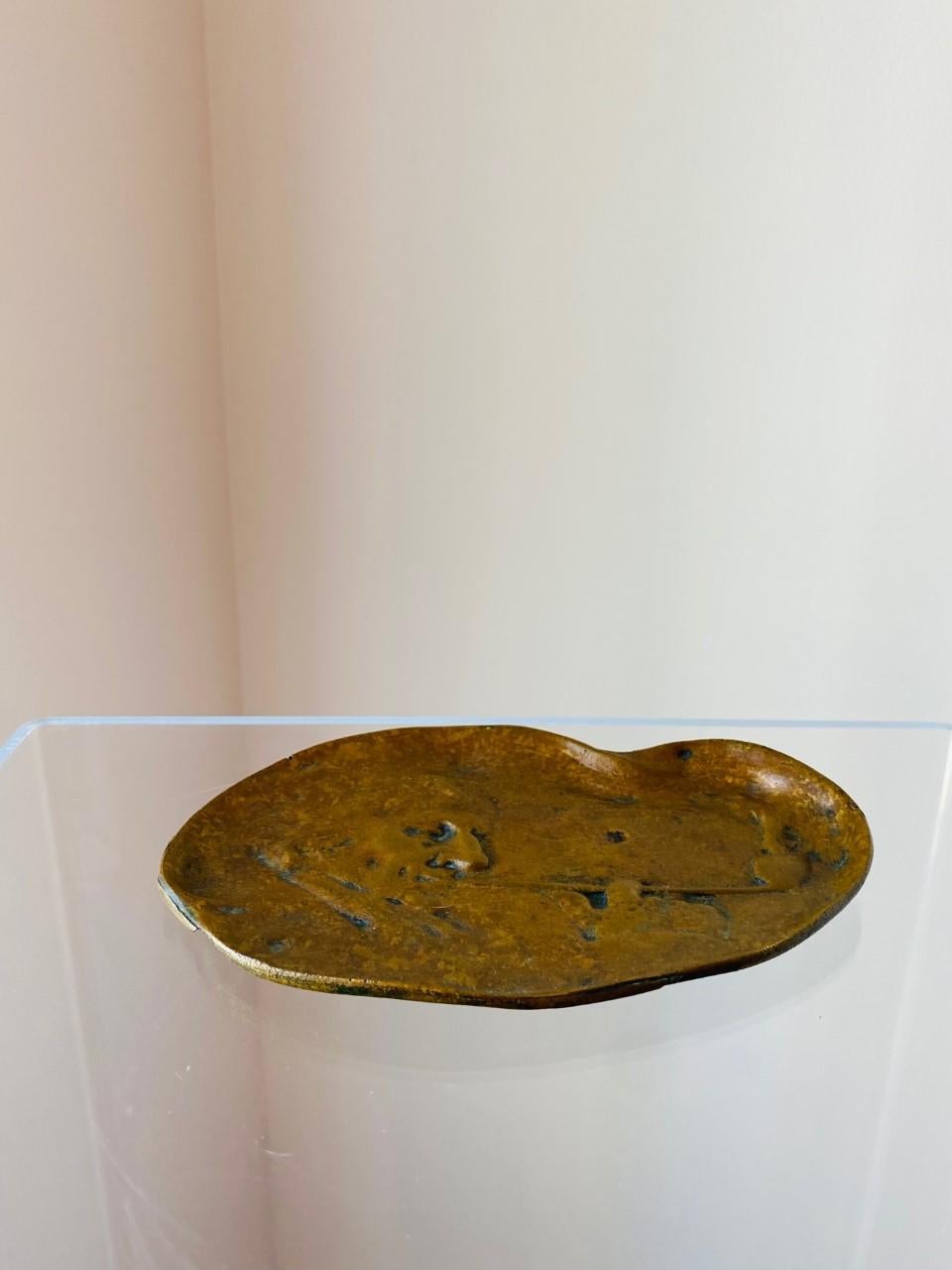Beautiful vintage small brass tray or ashtray titled “Smoker”. The brass relief image of the man and pipe is subtly hidden in the swirls of smoke and mist. This piece was acquired in France and accords with design features of the Art Nouveau period.