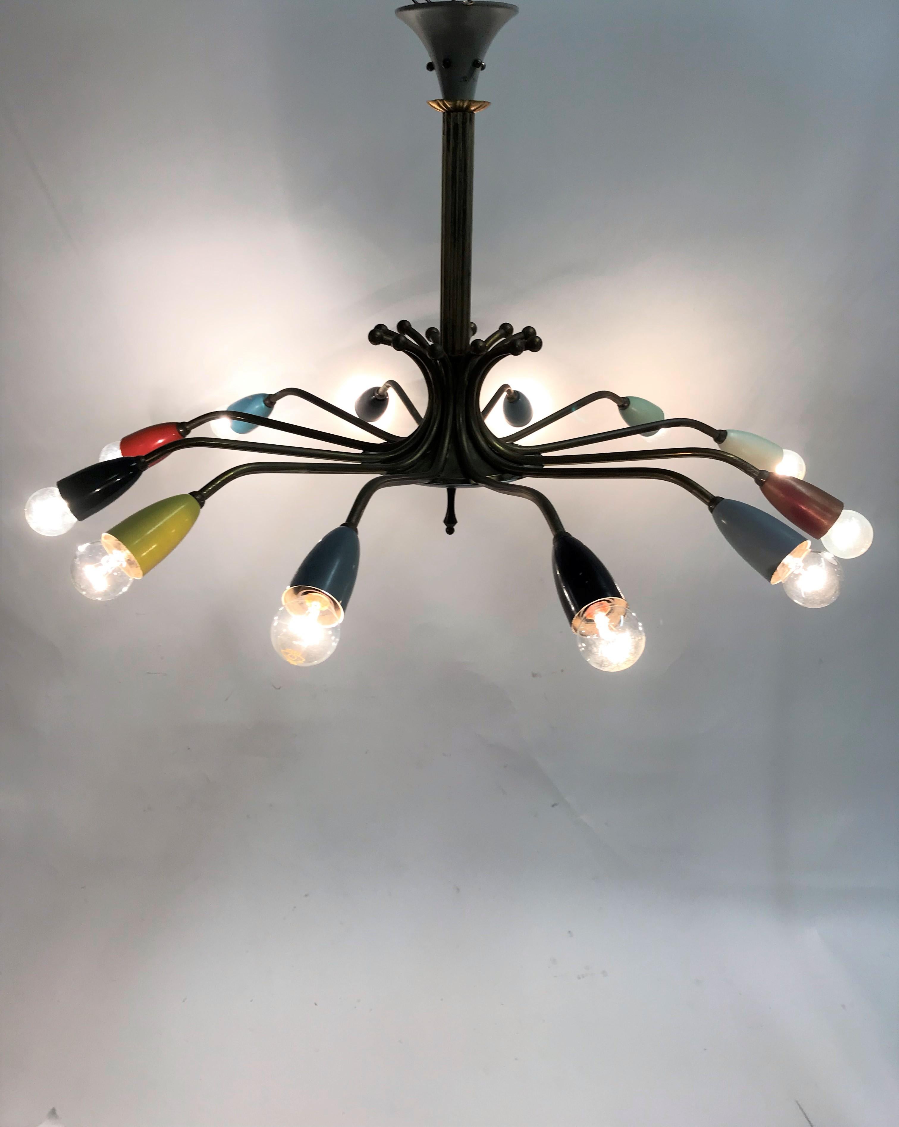 Beautiful midcentury 12-arm spider chandelier made from brass and lacquered metal. The Light bulb holders are made from metal as is rarely the case.

This charming high-quality chandelier is a wonderful original piece that could be the perfect