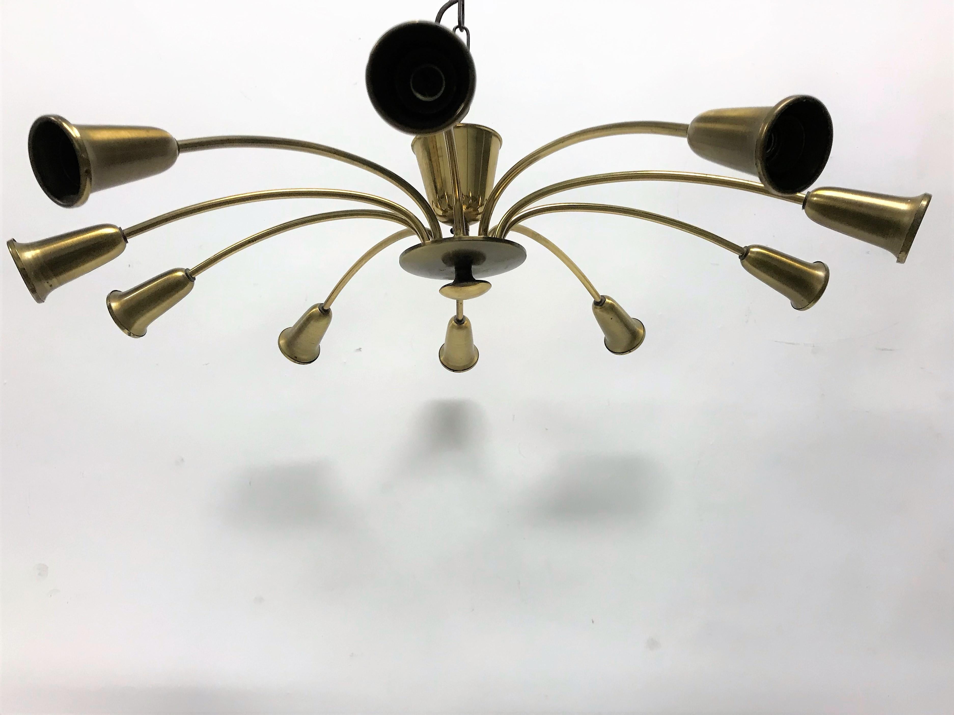 Brass spider chandelier with 10-light points.

The brass is slightly patinated, giving the light it's authentic character.

Tested and ready to use. Works with regular E14 light bulbs.

1960s, Italy

Dimensions:
Diameter 68 cm/ 27