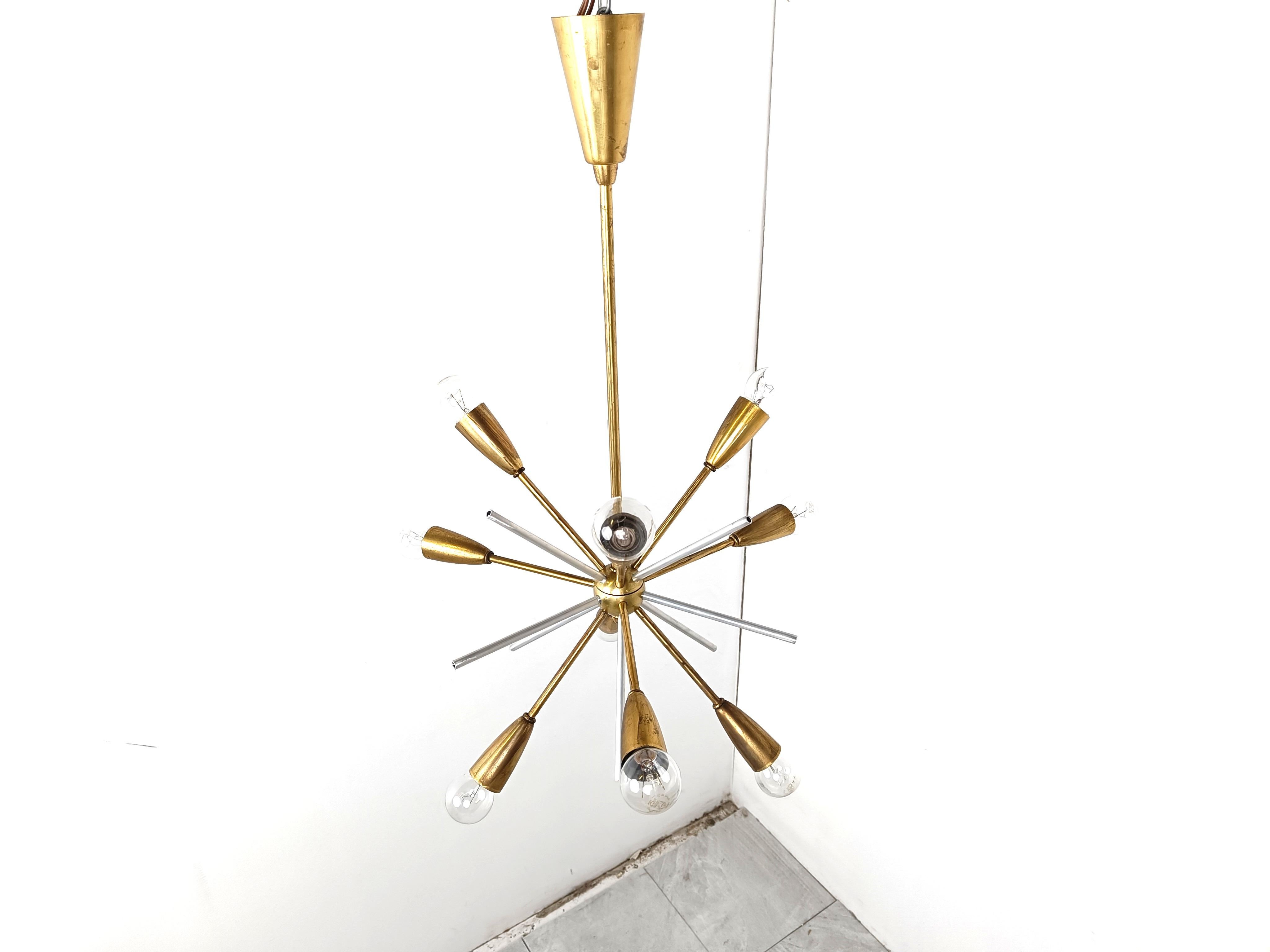 Rare brass and lucite sputnik chandelier.

The chandelier creates a stunning light effect.

Tested and ready for use. To be used with regular E14 light bulbs.

The chandelier is in good condition.

1970s - Belgium

Height: 70cm
Diameter: 45cm

Ref.:
