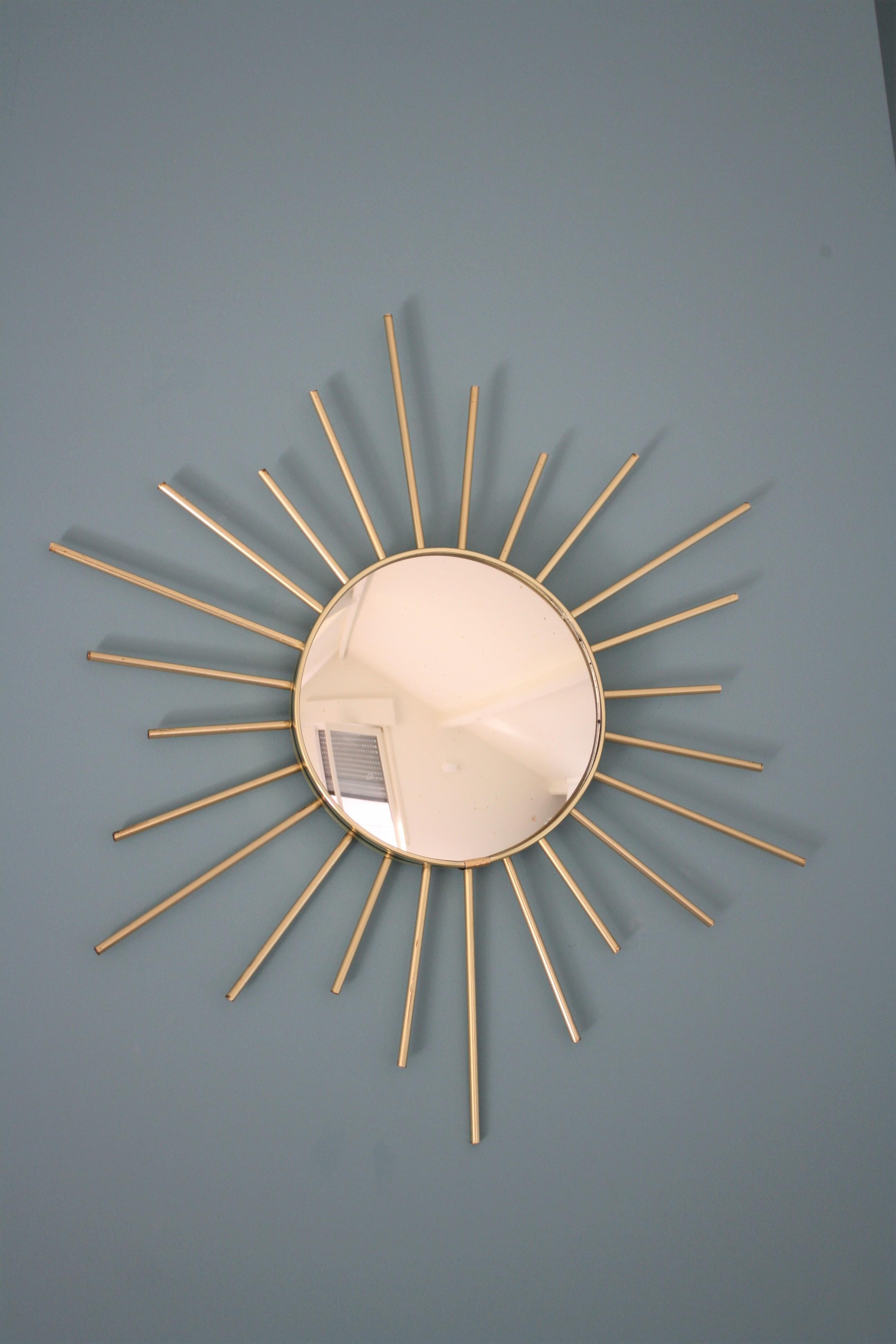 Charming vintage sunburst mirror with convex mirror glass. 

The Minimalist design makes it very useful in modern interiors.

Hollywood Regency style.

France, 1960s. 


Dimensions: 
Diameter 53 cm/ 20.86