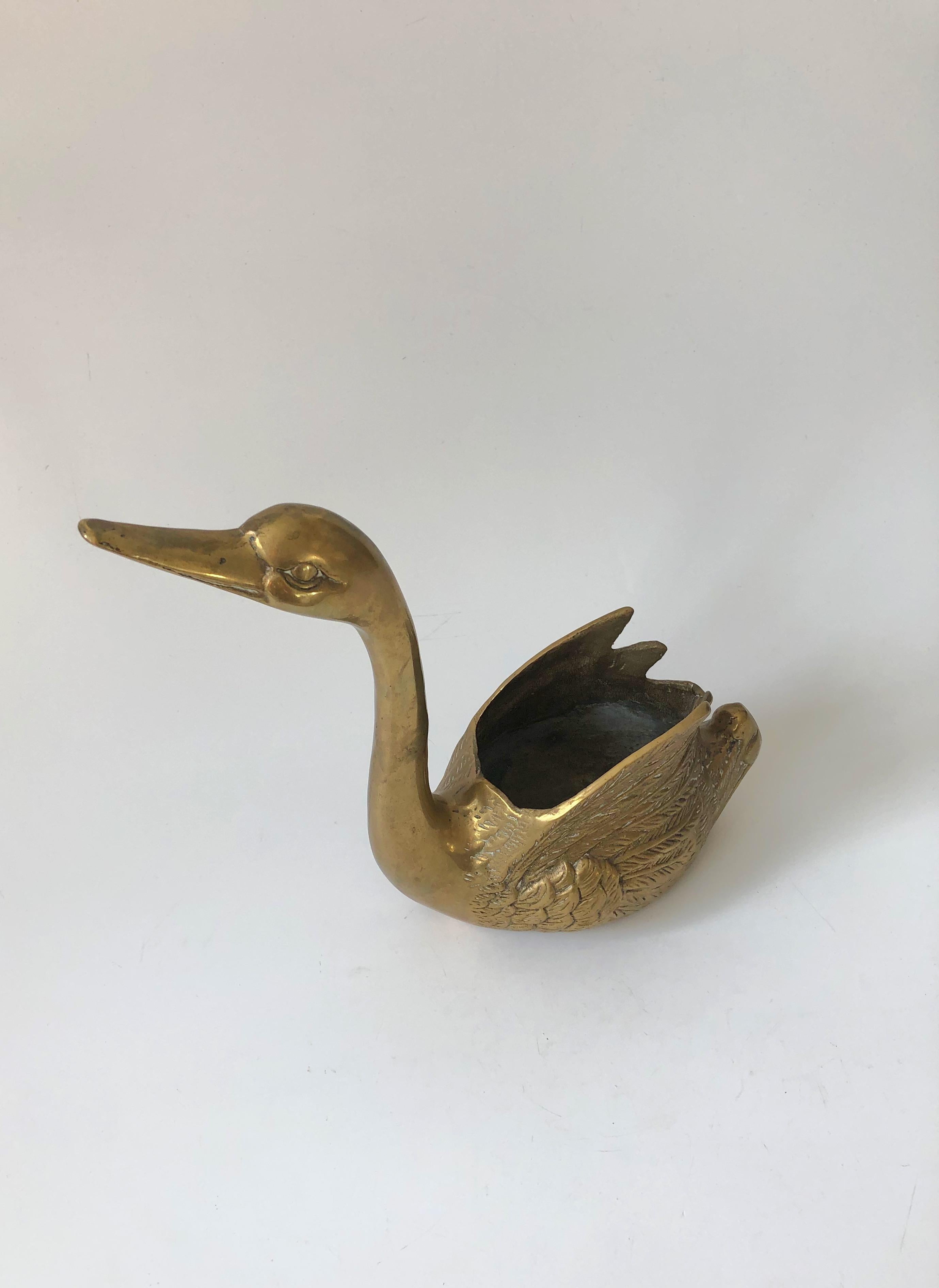 A vintage brass planter in the shape of a swan. Lovely graceful shape with beautiful detailing to the feathers formed into the brass.
 