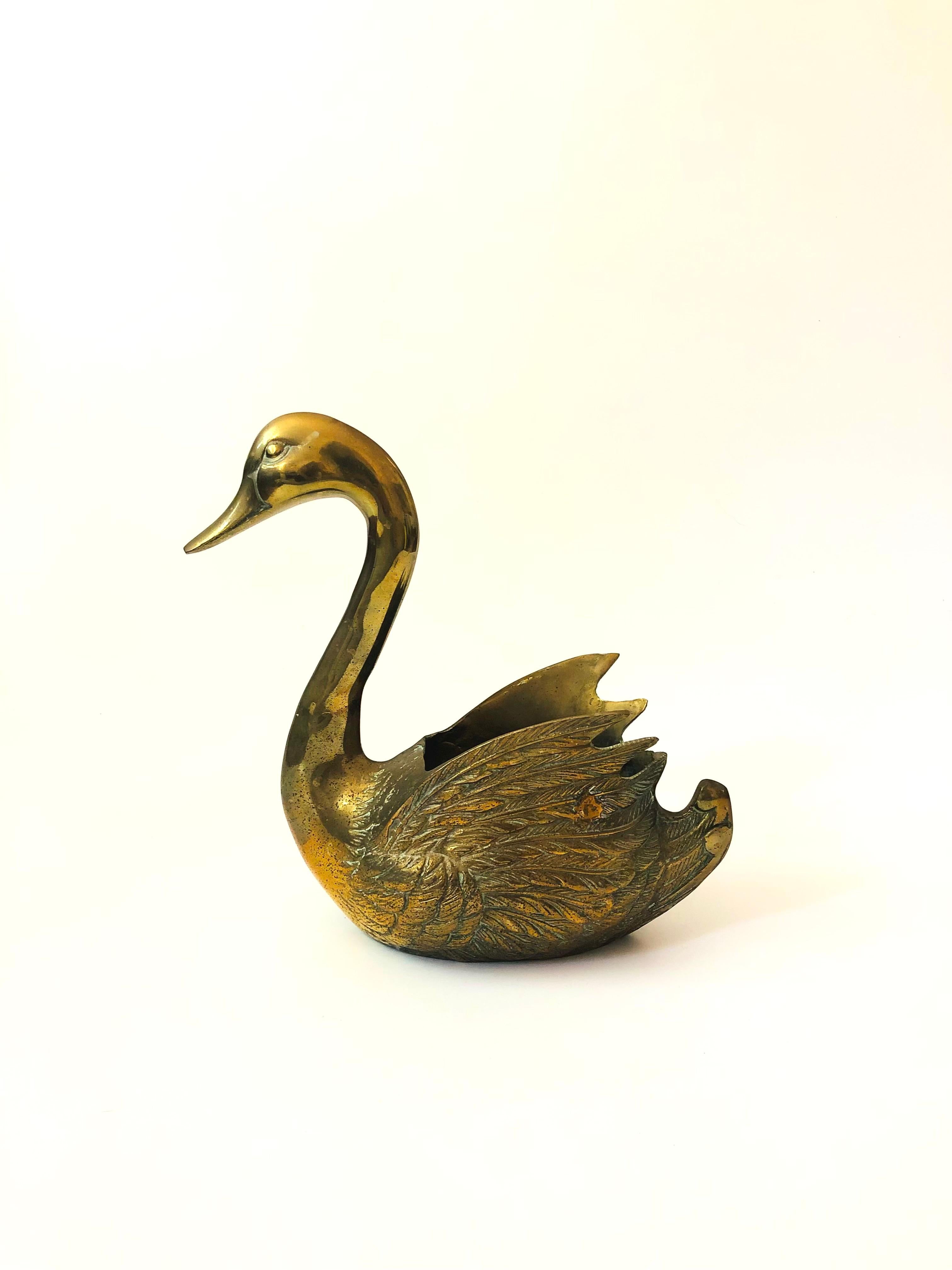 A vintage brass planter in the shape of a swan. Lovely graceful shape with beautiful detailing to the feathers formed into the brass.

