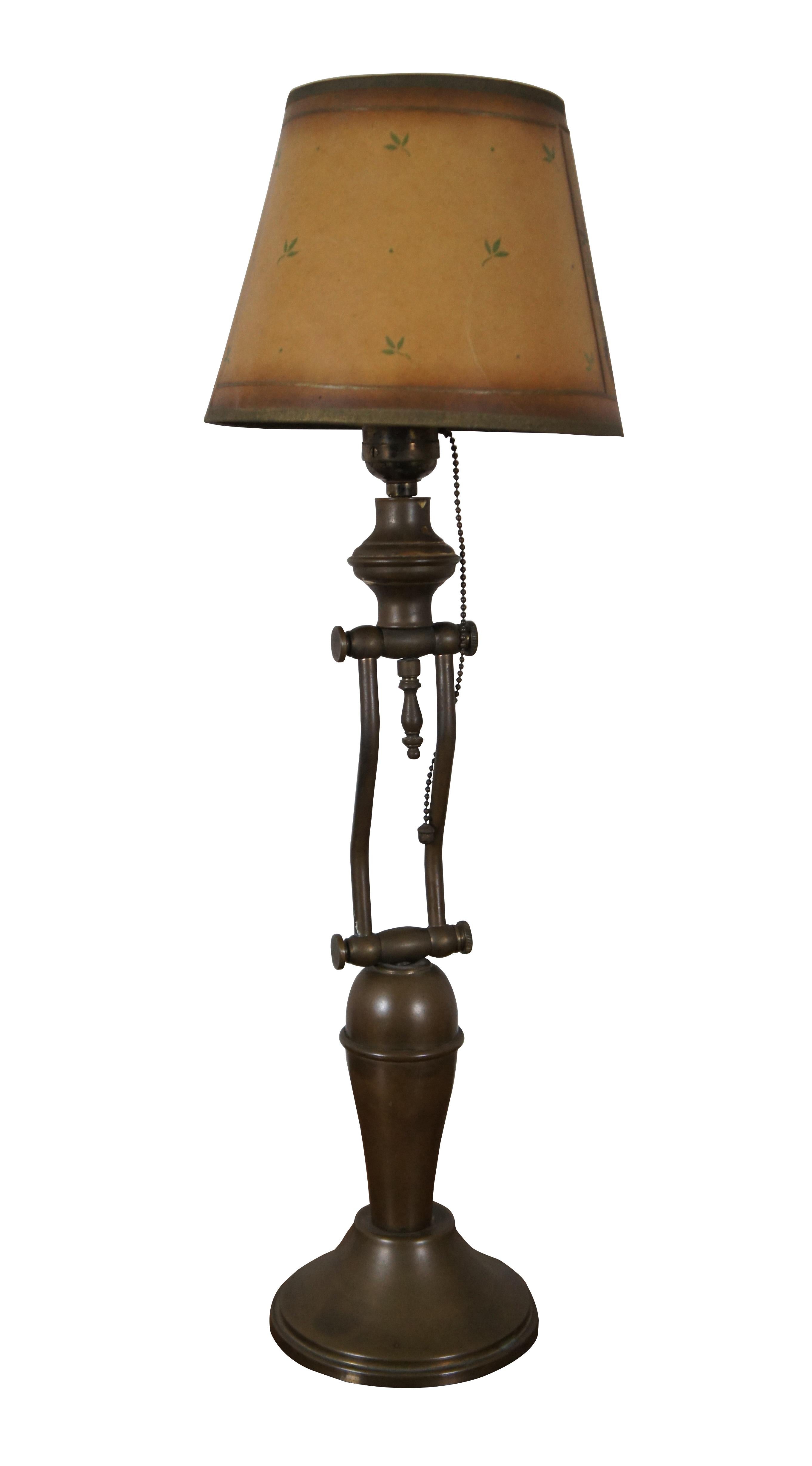 Vintage brass vanity desk / table lamp featuring articulating swing arm with pull chain, Hubbell socket and La Mode shade.

Dimensions:
5.5” x 10.5” x 13” / Maximum Height - 20” / Shade - 8.25” x 6” (Width x Depth x Height)