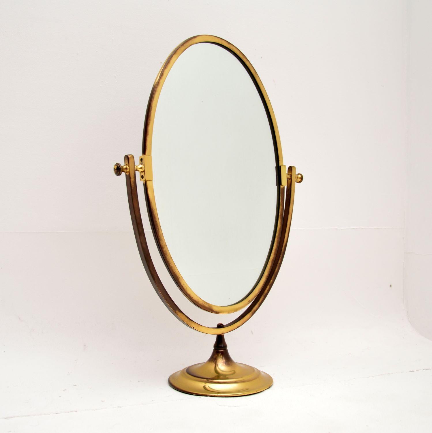 A fantastic vintage brass table top vanity mirror. This was made in England it dates from the 1950’s.

It is much larger than those more commonly seen, the quality is superb. The mirror can be tilted to various angles, the back is finished in brown