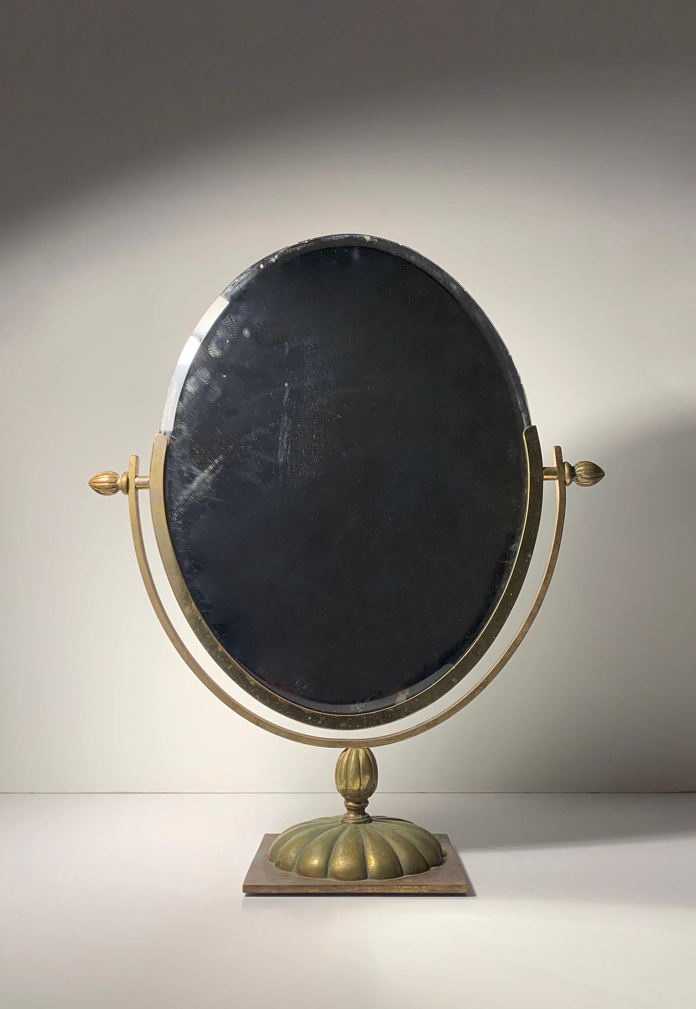 A nice early vintage brass vanity table mirror. Uncertain to origin. May possibly be Italian. It appears to have a fair amount of handcrafted components. Nice early molds for the brass castings. A nice heavy piece. The mirror shows a lot of age with