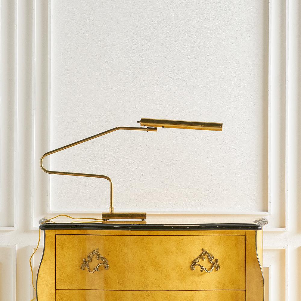 An elegantly shaped brass task lamp, sourced in Mexico City. The lamp head can be angled in various positions. Unlacquered brass has a warmth and richness to its patina. 

Dimensions: 31
