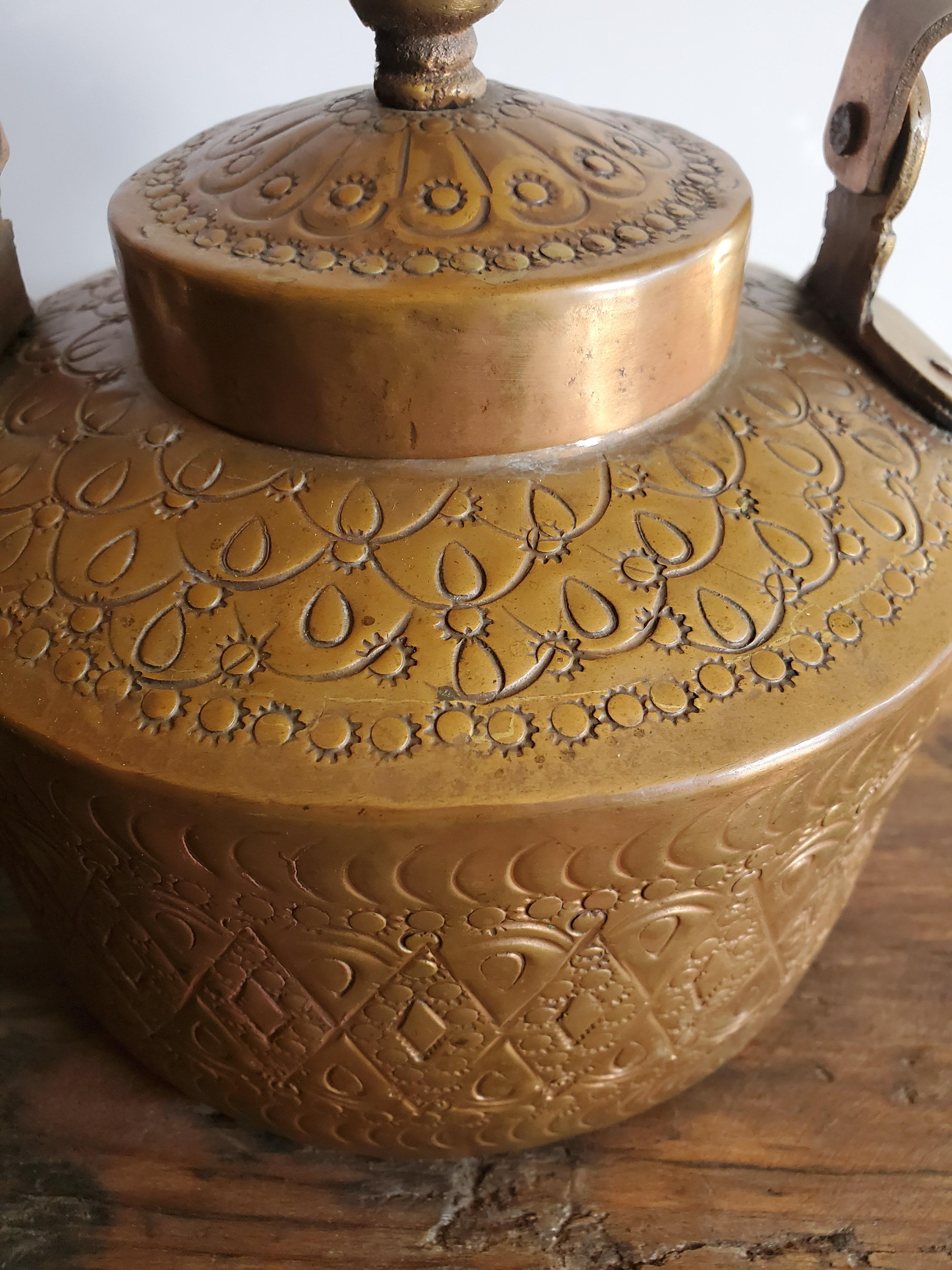 Made from pure copper, this beautiful Moroccan tea kettle is a few decades old, and has signs of wear and tear. Great for decoration with its amazing hammering patterns throughout.
Measuring approximately 9
