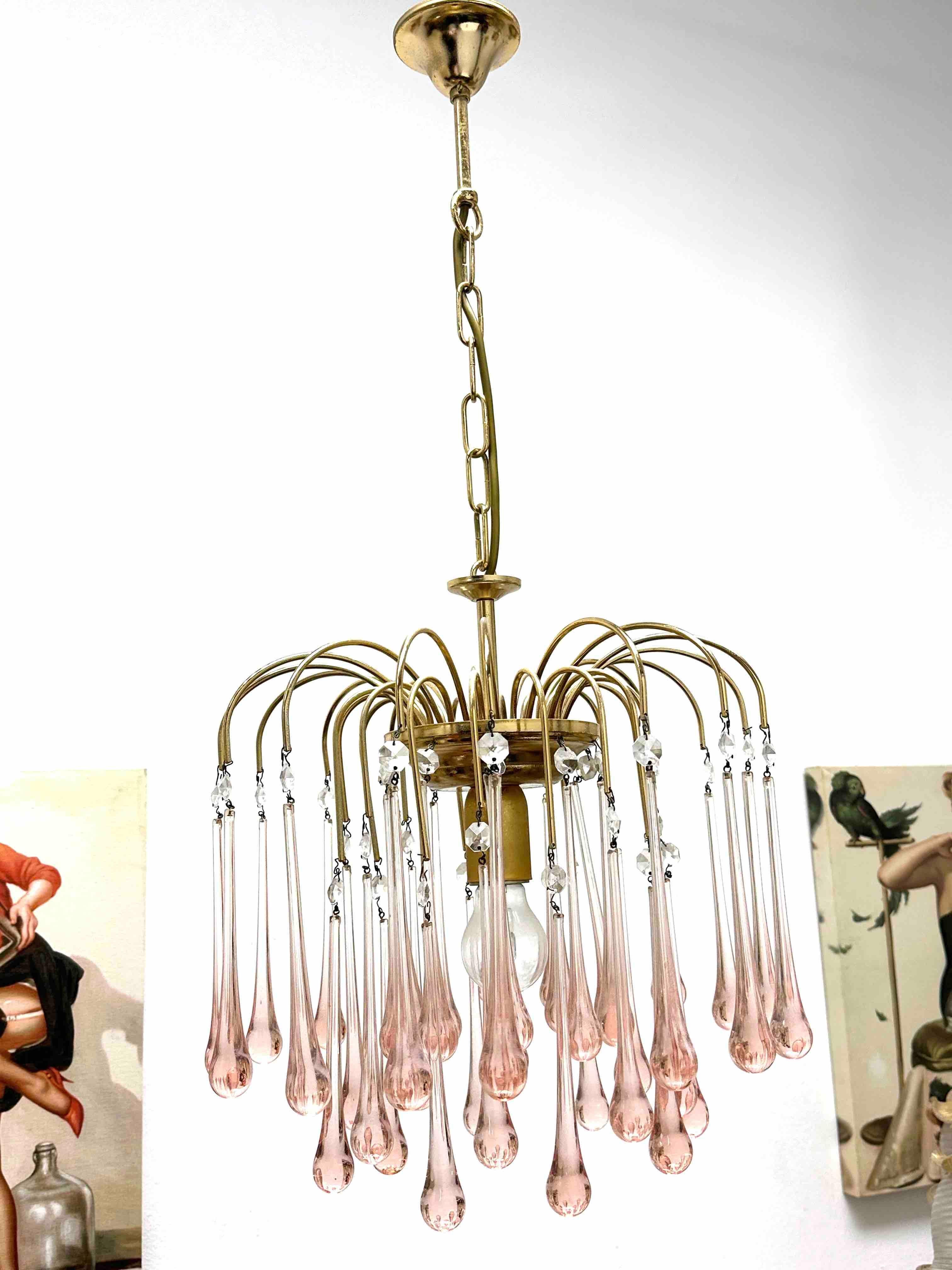 Stunning crystal waterfall chandelier. The piece is made of brass and detailed with three layers of pink crystal glass teardrops. This will make a beautiful addition to your Vanity room or probably bedroom. Your item will be carefully packed.