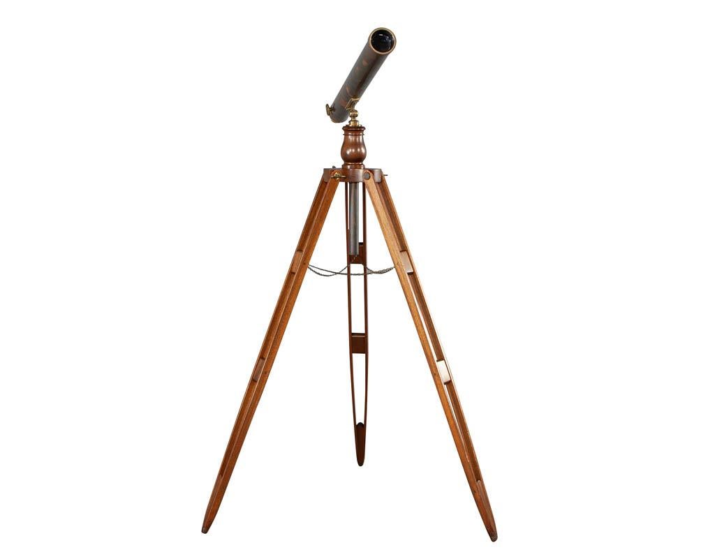 Vintage brass telescope on walnut tripod stand. Sold as is for decorative purposes. Country of origin and manufacturer unknown. Estimated age circa 1950-1960s. Beautiful aged patina on brass and metal.

Price includes complimentary curb side