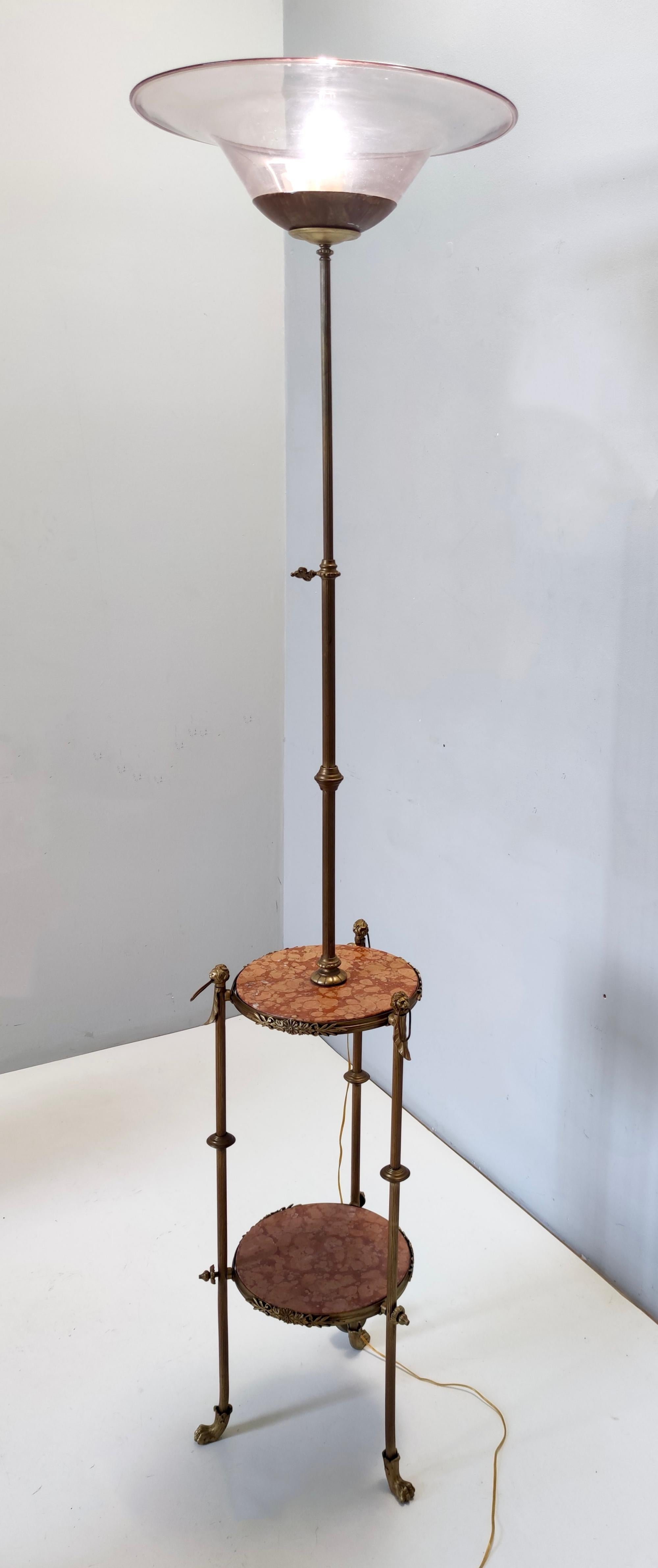 Made in Italy, 1920s. 
It features a brass and varnished steel frame with a red travertine tops and a Murano glass lampshade, which is hand blown by Vittorio Zecchin.
It is a Renaissance Revival style. 
It is a vintage piece, therefore it might show