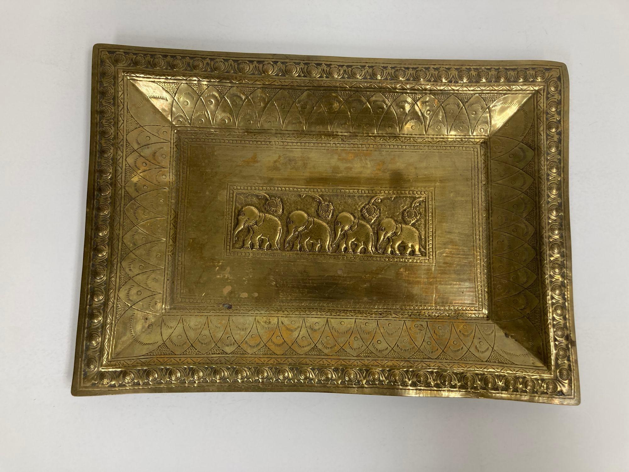 Vintage Mughal Indian brass repousee with baby elephants motif engraved brass charger serving tray.
Vintage Serving metal rectangular tray, platter engraved and finely decorated with elephants and repousse with a wide border in geometric embossed