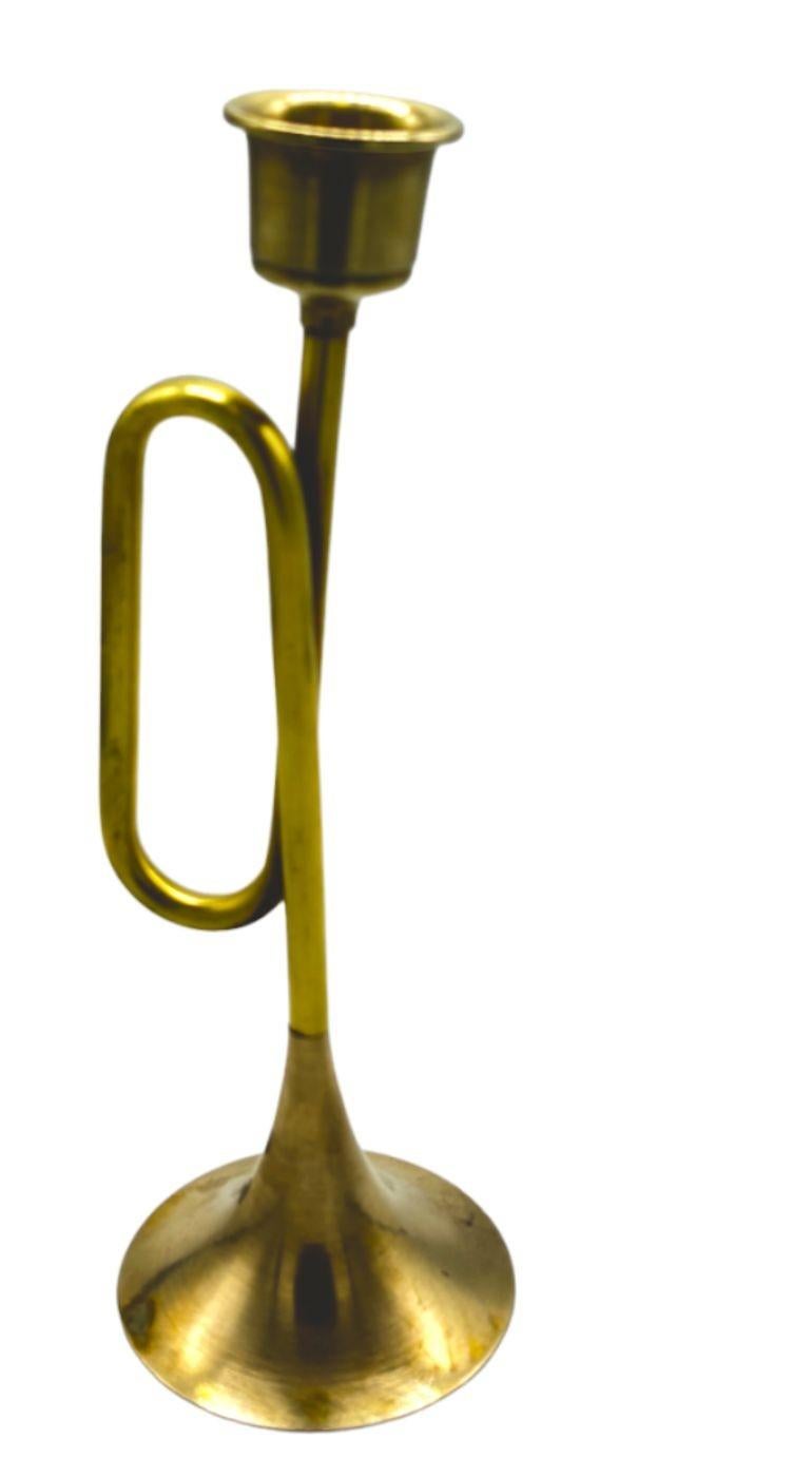 The Brass Trumpet Candlestick Holder exudes the timeless charm of mid-century modern design. Drawing inspiration from the sleek and streamlined aesthetics of the 1950s and 1960s, this candlestick holder features a trumpet-shaped silhouette crafted