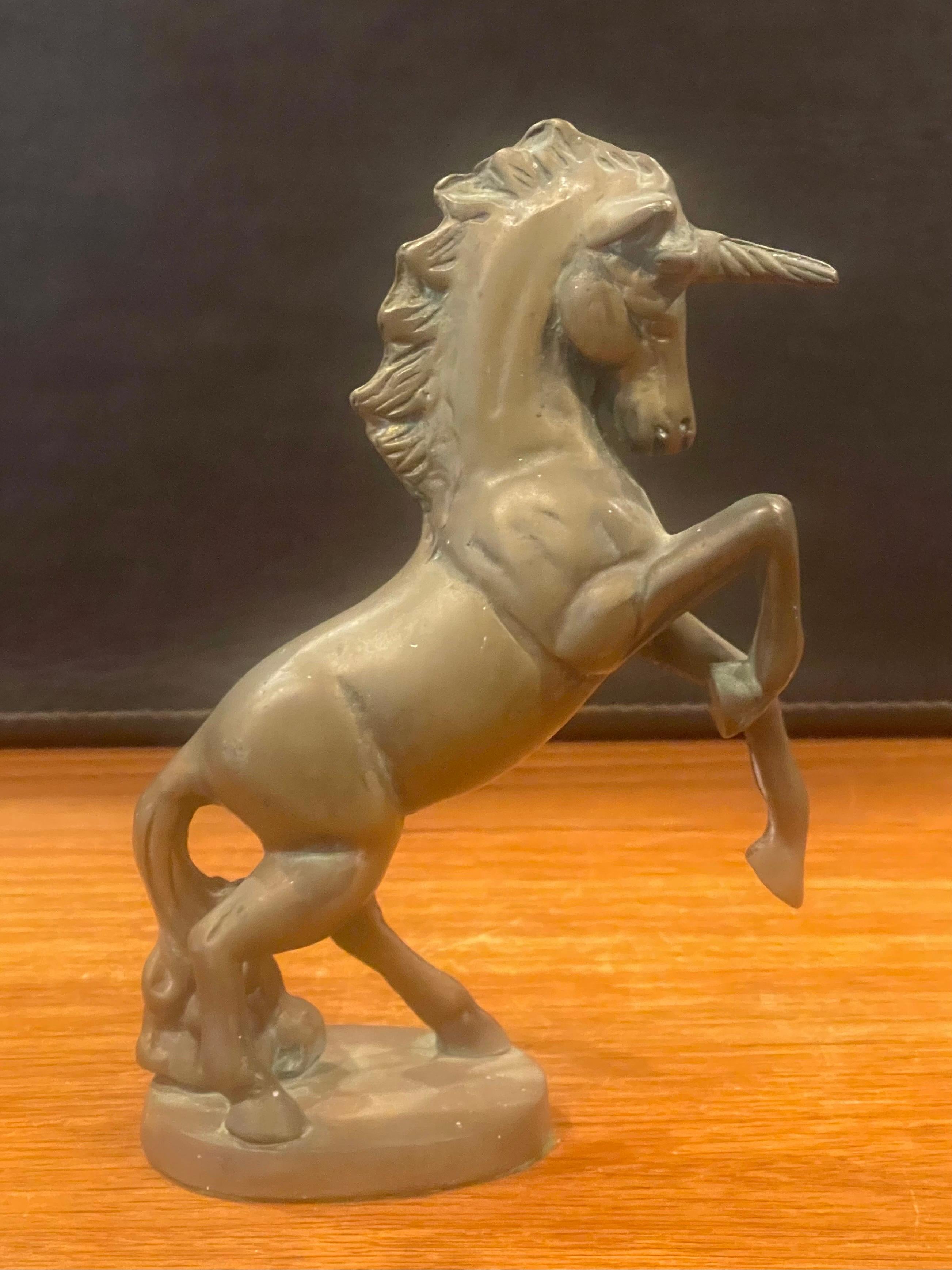Vintage solid brass unicorn sculpture circa, 1970s. The piece is in good vintage condition with a great patina and measures 3