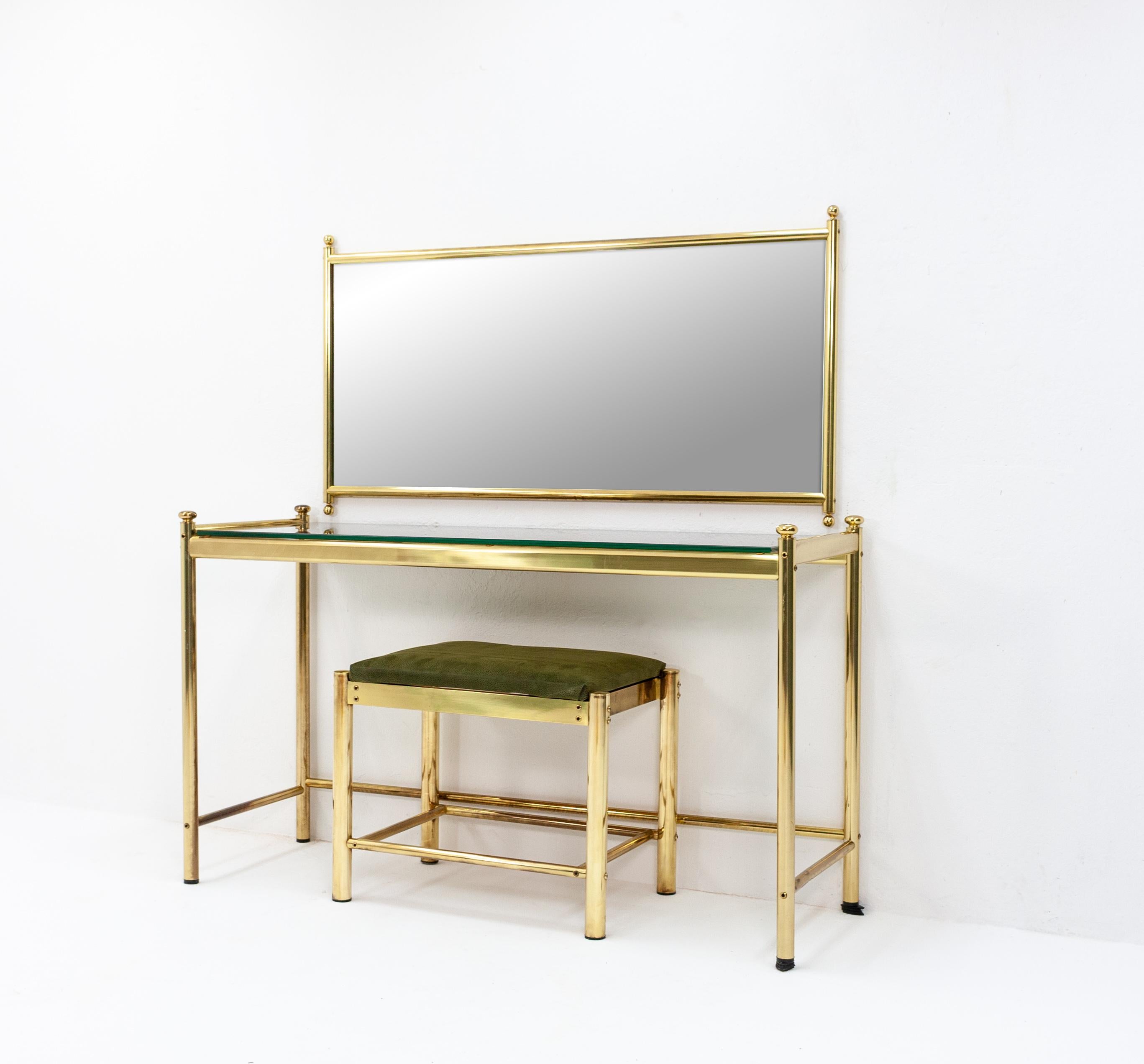 Luxurious brass Finn mirror vanity set consisting of a glass table with a smoked glass top, a wide mirror and a low seat with green upholstery. Great heavy quality plating and glass, 1970s, Finland. Very good quality.