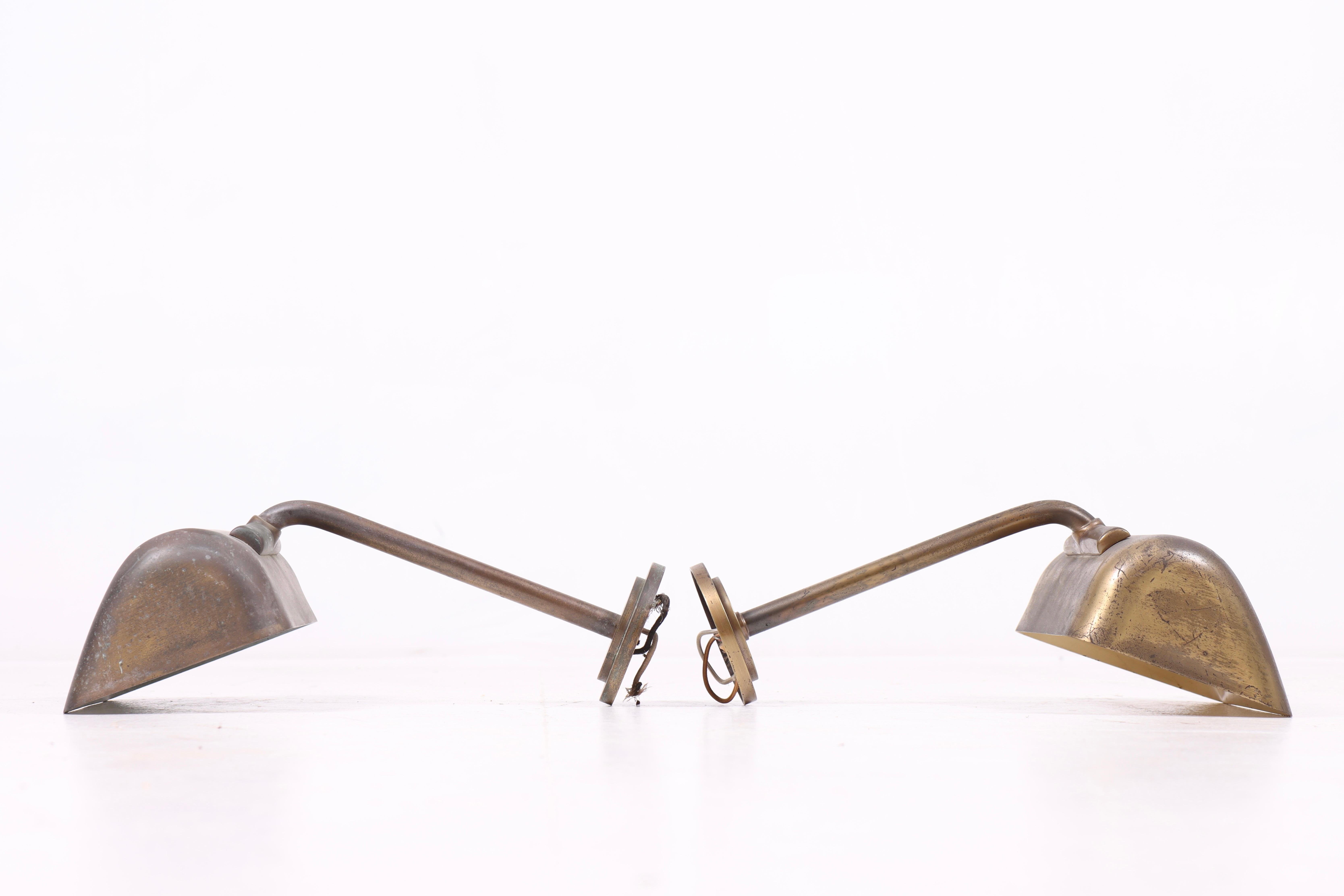 
These two wall lamps from the 1940s are crafted from brass and produced in Denmark. They are attributed to Palle Suenson, a prominent Danish architect and designer known for his clean lines and functional designs that seamlessly blend beauty with