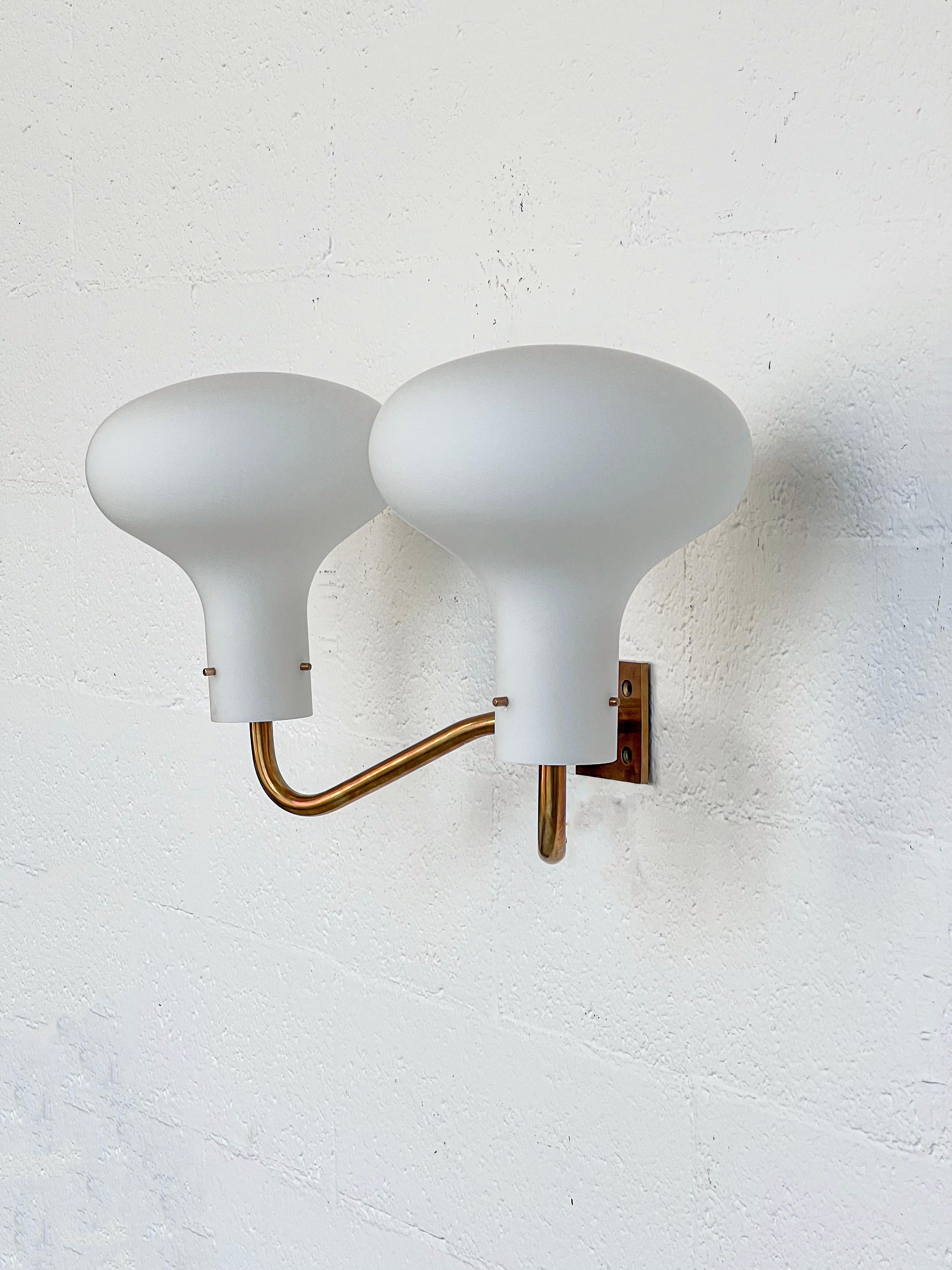 Available is a pair of vintage Italian LP12 sconces by Ignazio Gardella, brass frame and opaline glass mushroom-shaped lightshades. Some collectors indeed nickname these lamps 