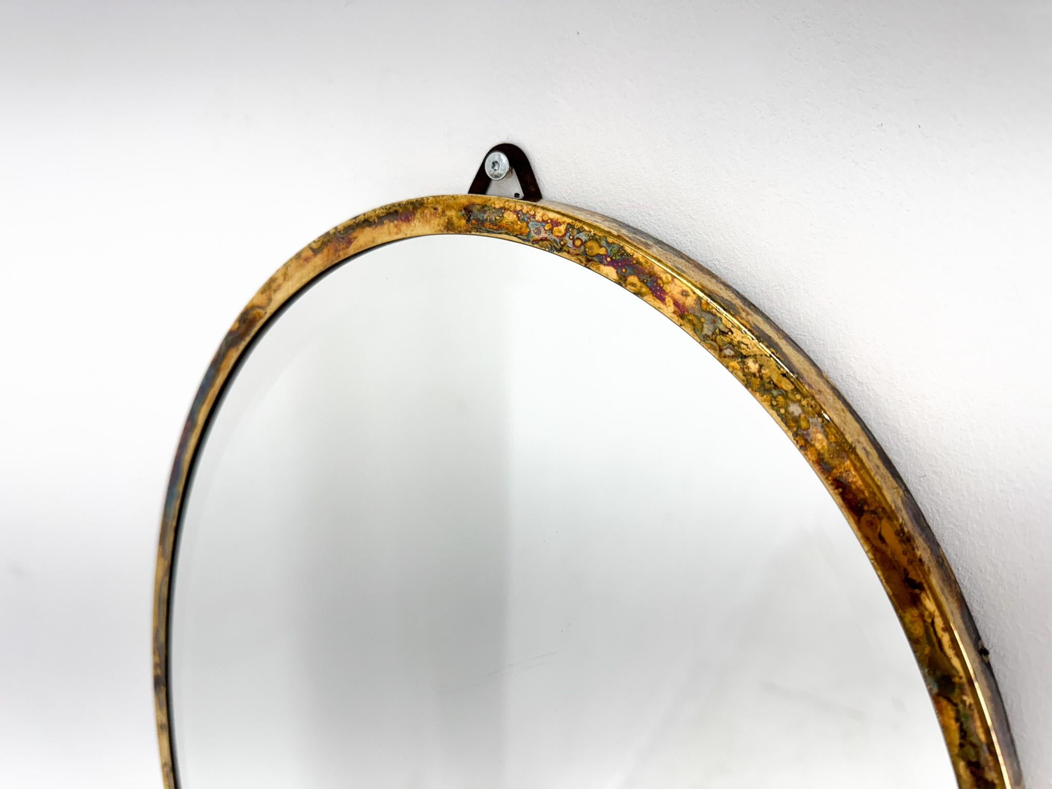 Wall mirror with facet in brass frame. Made in France in the 1950's.