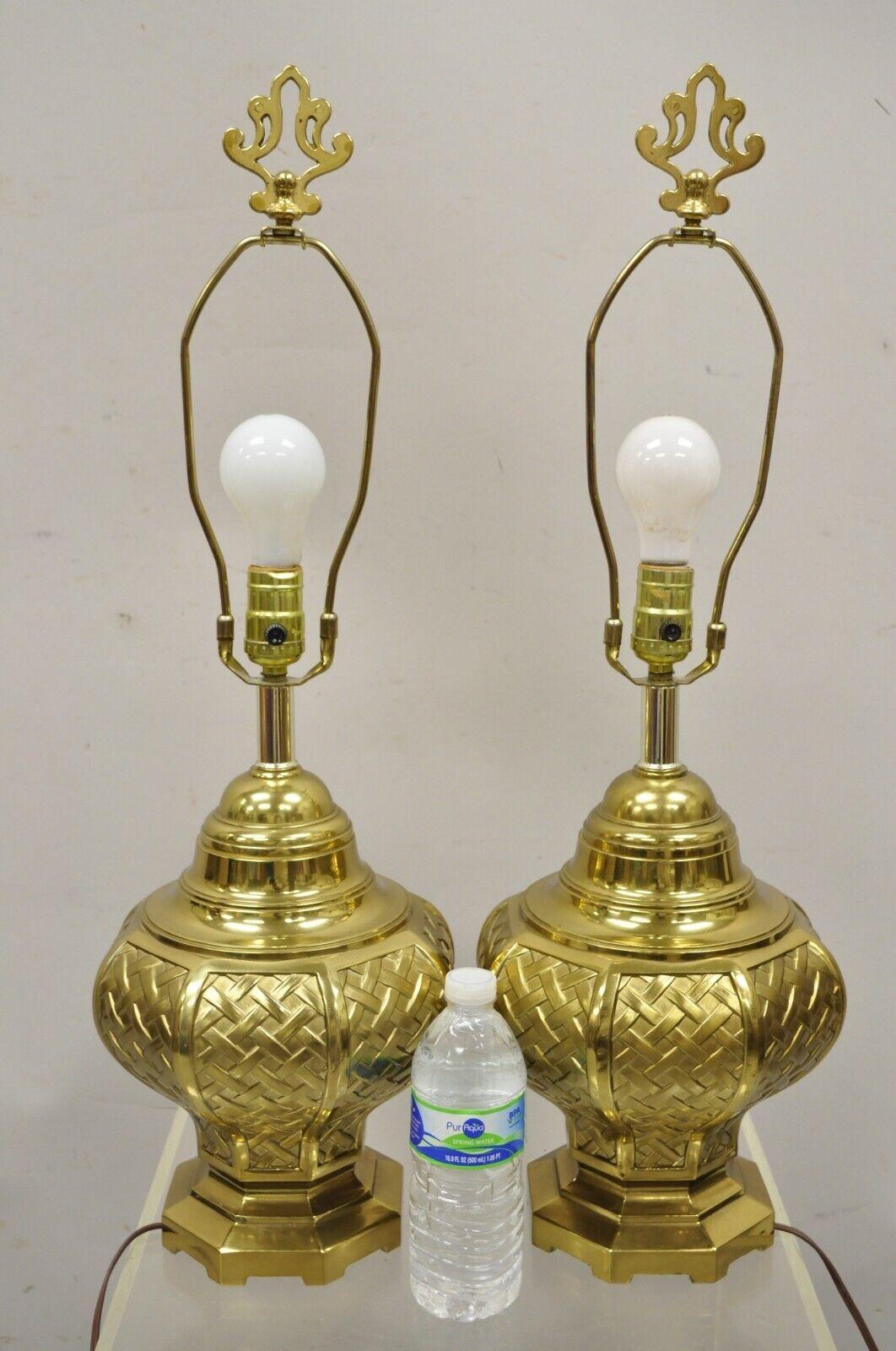 Vintage brass woven basket basketweave Hollywood Regency table lamps - a pair. Item features ornate finials, basketweave woven bodies, very nice vintage pair, great style and form. Circa mid to late 20th century. Measurements: 27