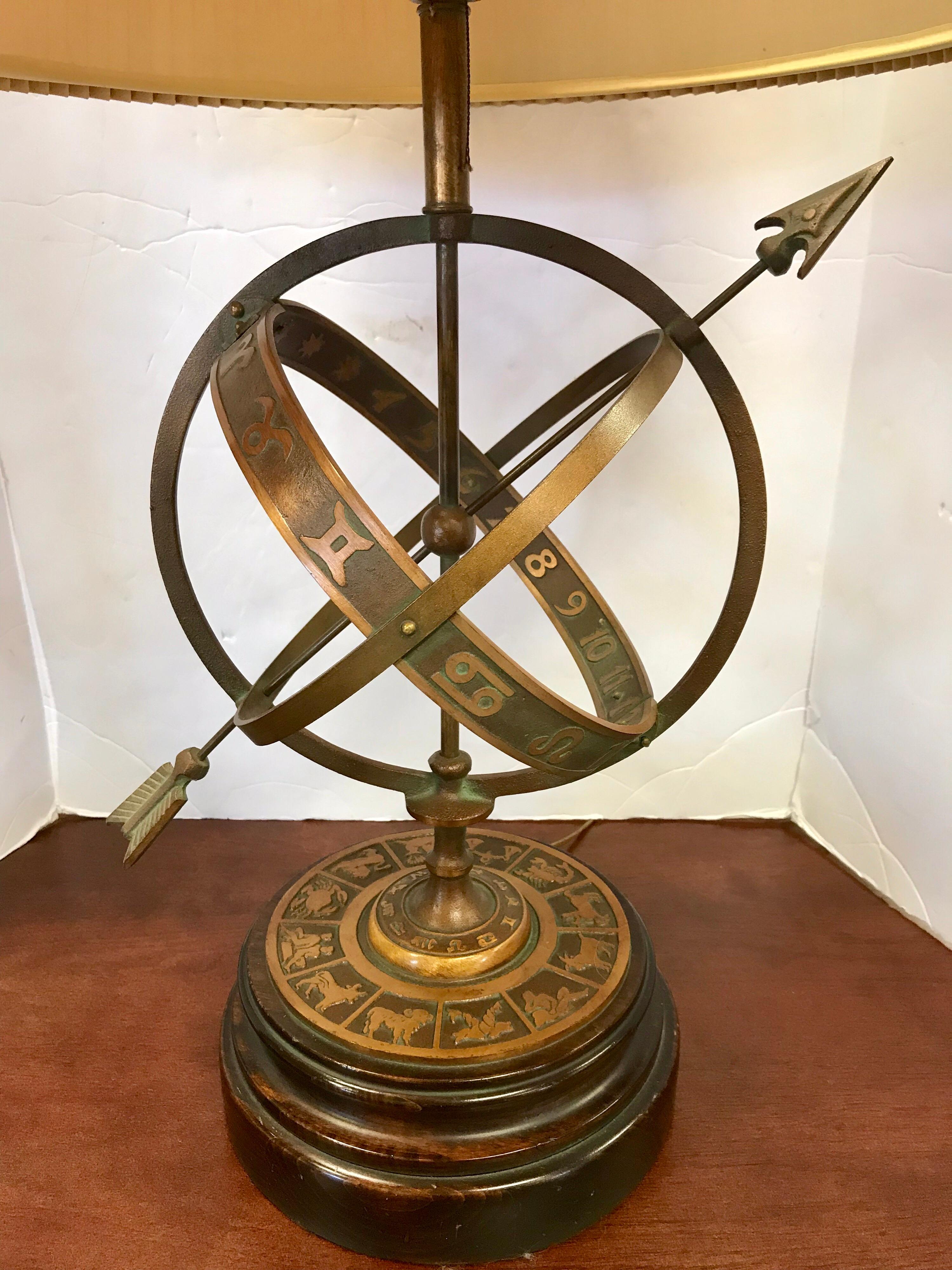 Very large Armillary sphere lamp with an astrological zodiac sign motif all around. Antique brass finish. Lamp has a substantial wood base and includes a large pleated lamp shade.
Shade measures 19” W x 15” H.