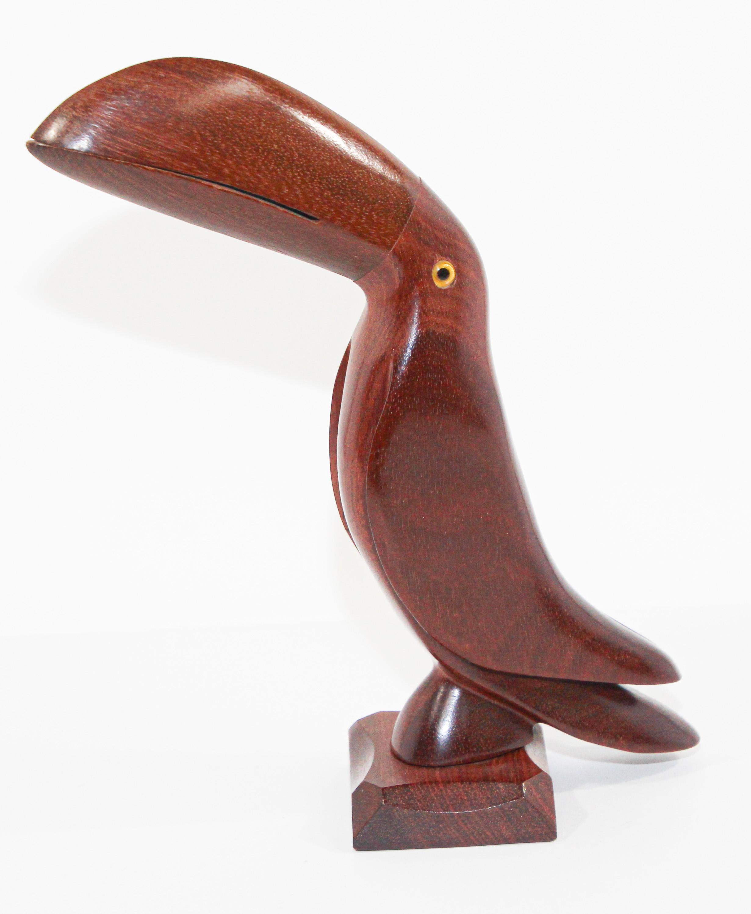 Vintage Brazilian hand carved Ironwood sculpture of a toucan.
Hand carved Brazilian toucan bird sculpture with glass eyes. 
Hand crafted in amazing detail from one of earth's hardest natural ironwood. 
This is an authentic art piece crafted of