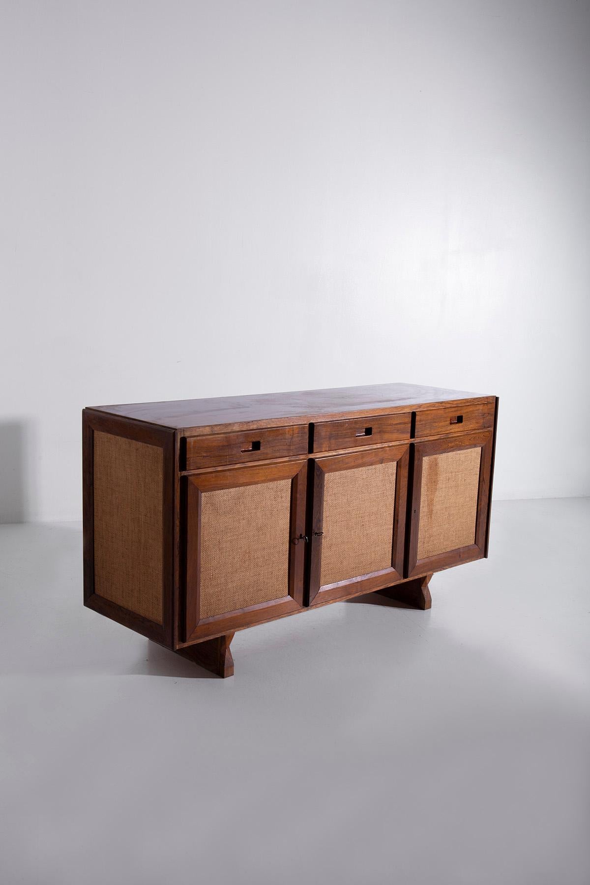 Step into the enchanting world of 1950s Brazilian design, where elegance and craftsmanship intertwine to create a truly exceptional vintage wooden sideboard. This timeless piece, a testament to the artistic sensibilities of its era, exudes an air of